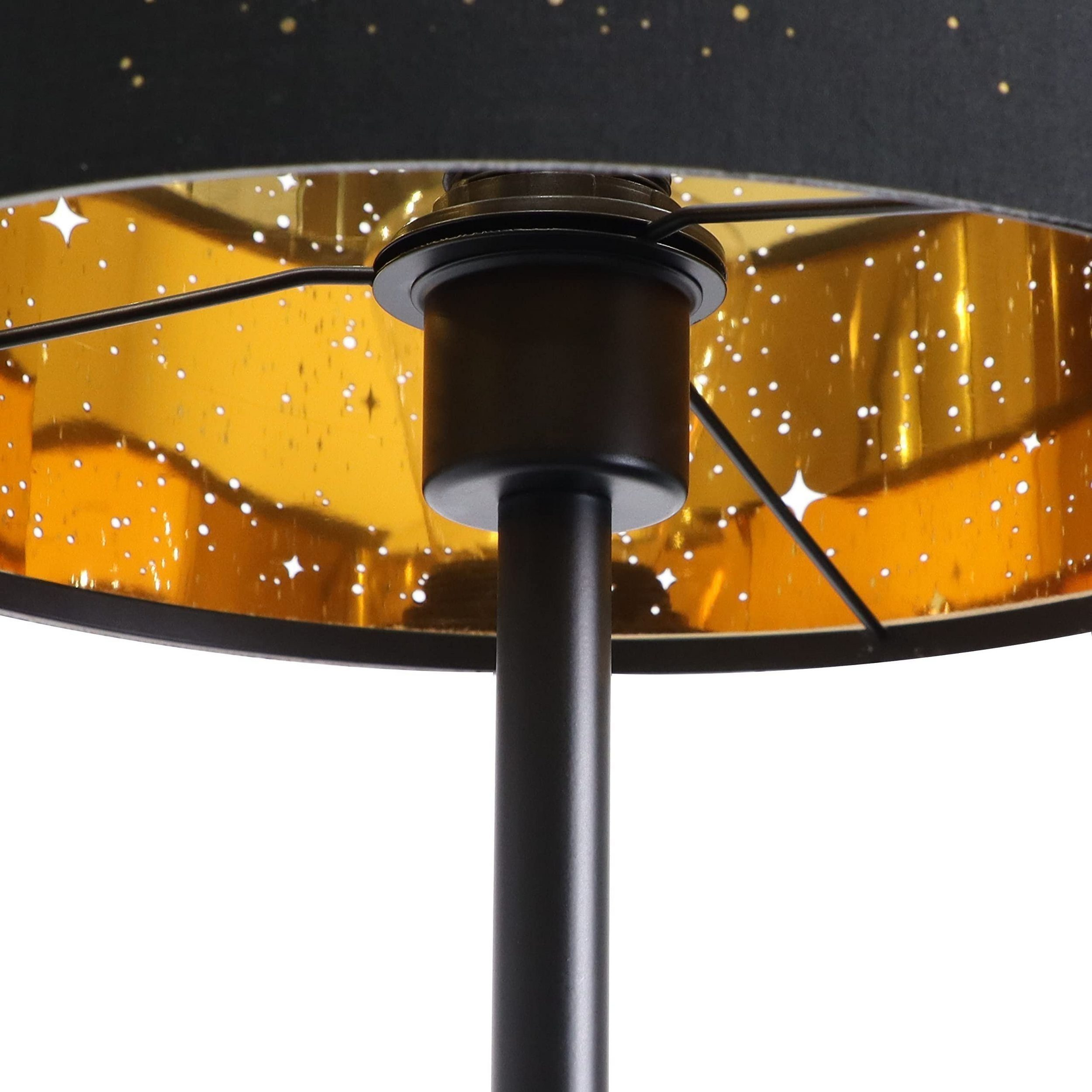 Lampa z czarną podstawą i złotym wnętrzem, czarnym abażurem. Lampa emituje światło.