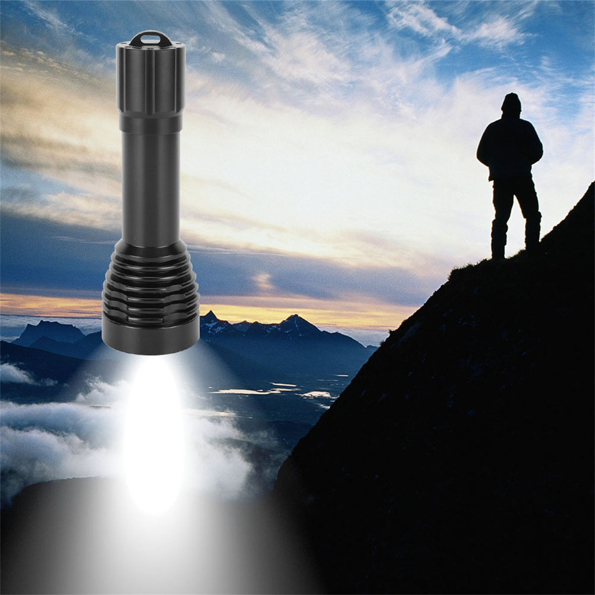 Schwarze Taschenlampe, die helles Licht scheint. Eine Person ist auf einem Berg vor einem bewölkten Himmel bei Sonnenuntergang silhouettiert.