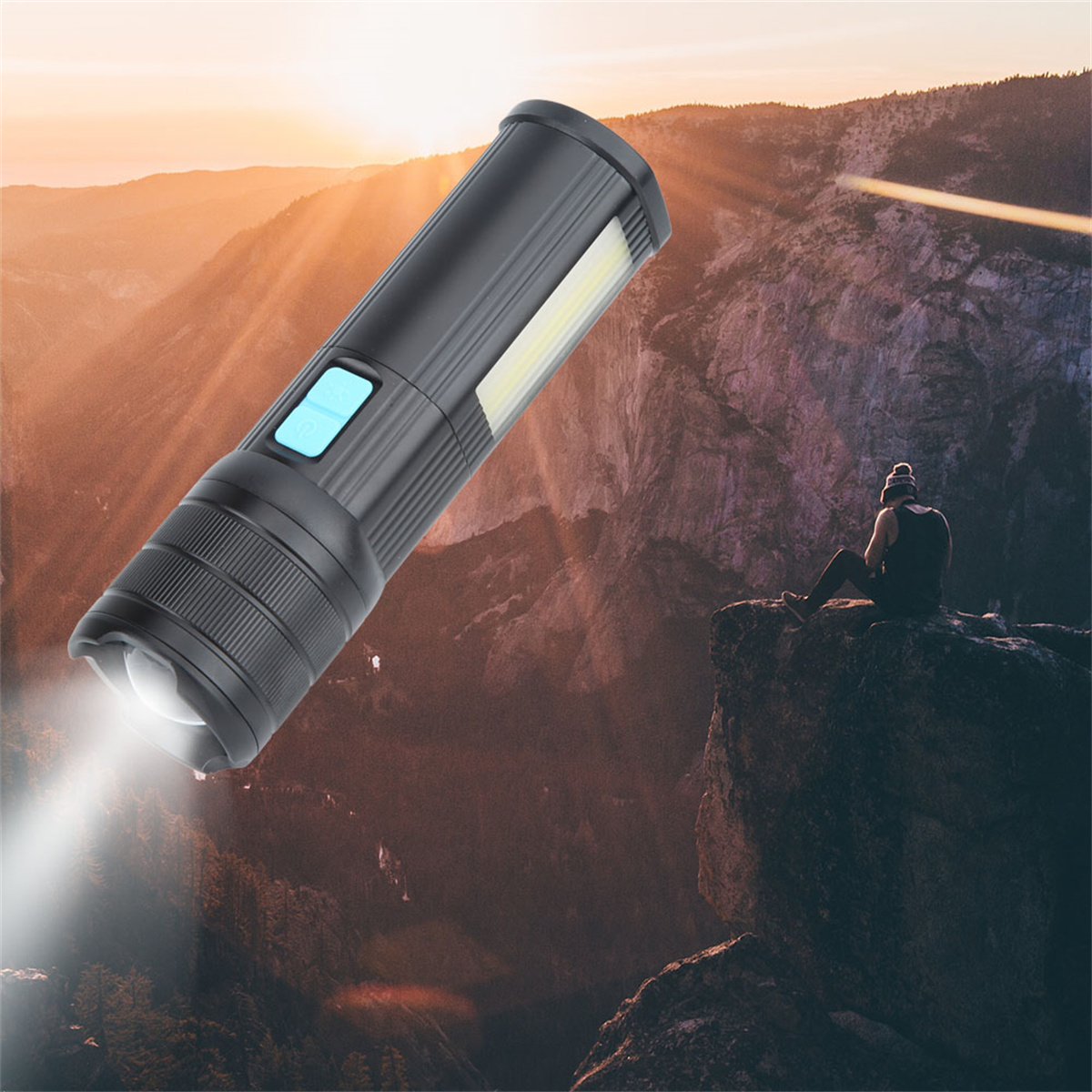 Schwarze Taschenlampe, die über einer Berglandschaft leuchtet. Eine Person sitzt.