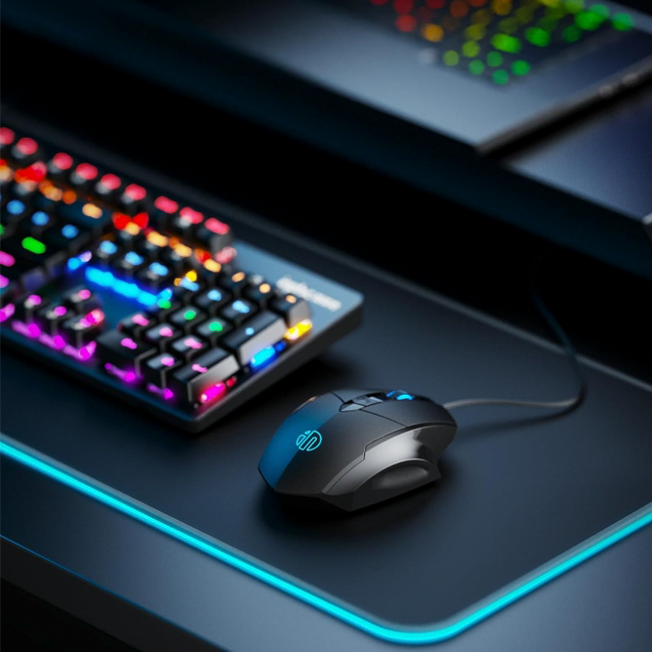 Ein Gaming-Setup mit einer farbenfrohen Tastatur und Maus. Die Tastatur leuchtet und die Maus befindet sich auf einem schwarzen Mauspad.