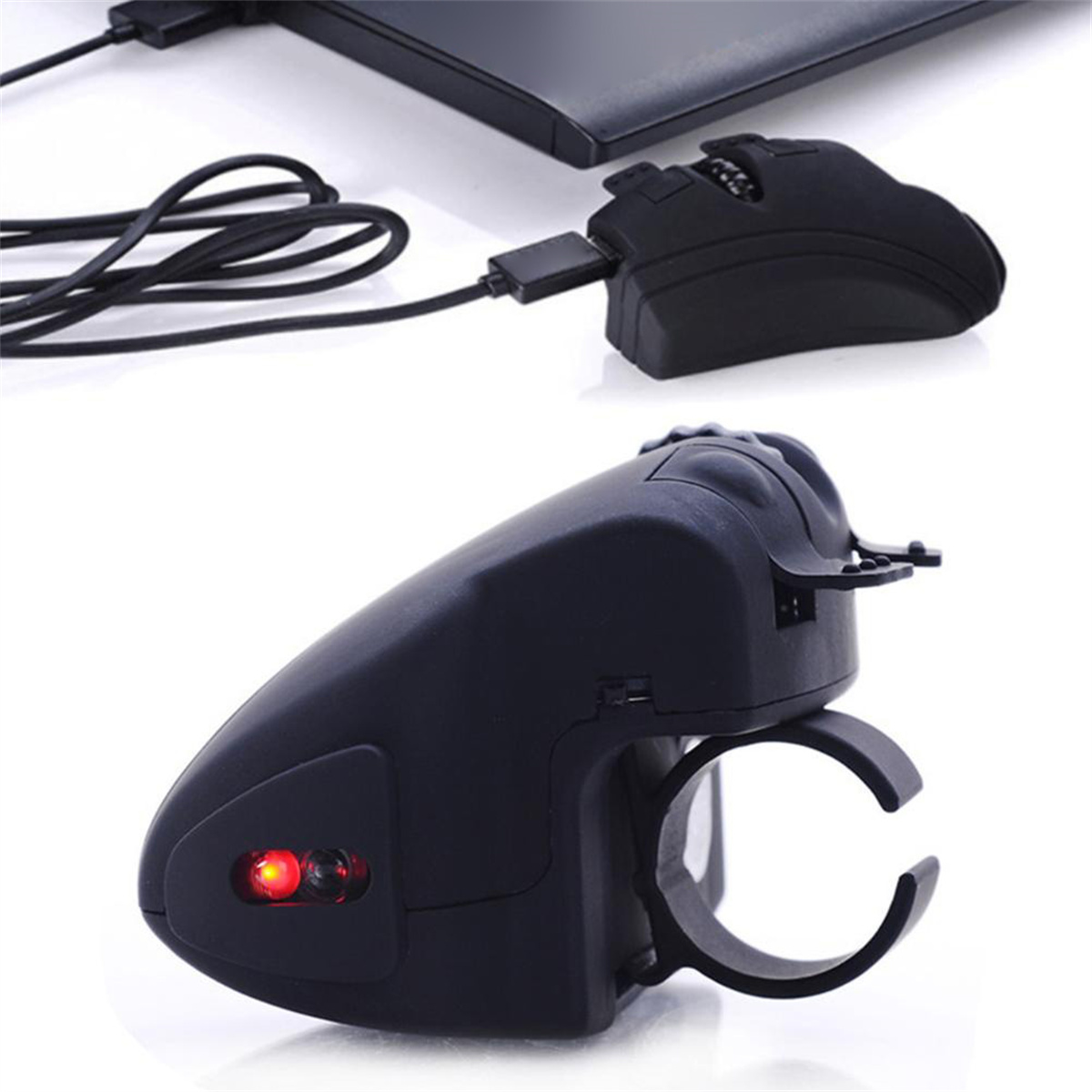 Eine schwarze Maus mit Fingerring und rotem Licht.