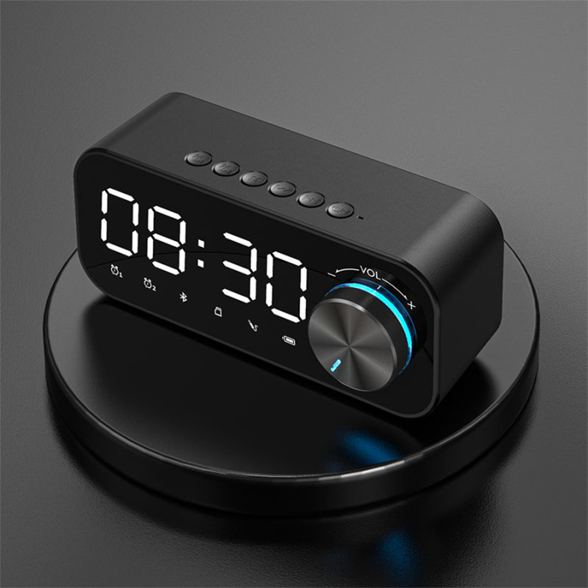 Ein schwarzer digitaler Wecker mit der Anzeige 08:30 auf einer schwarzen runden Basis.