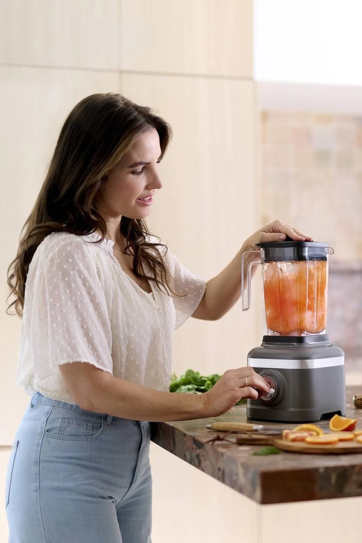 White ice cream maker with a transparent lid.