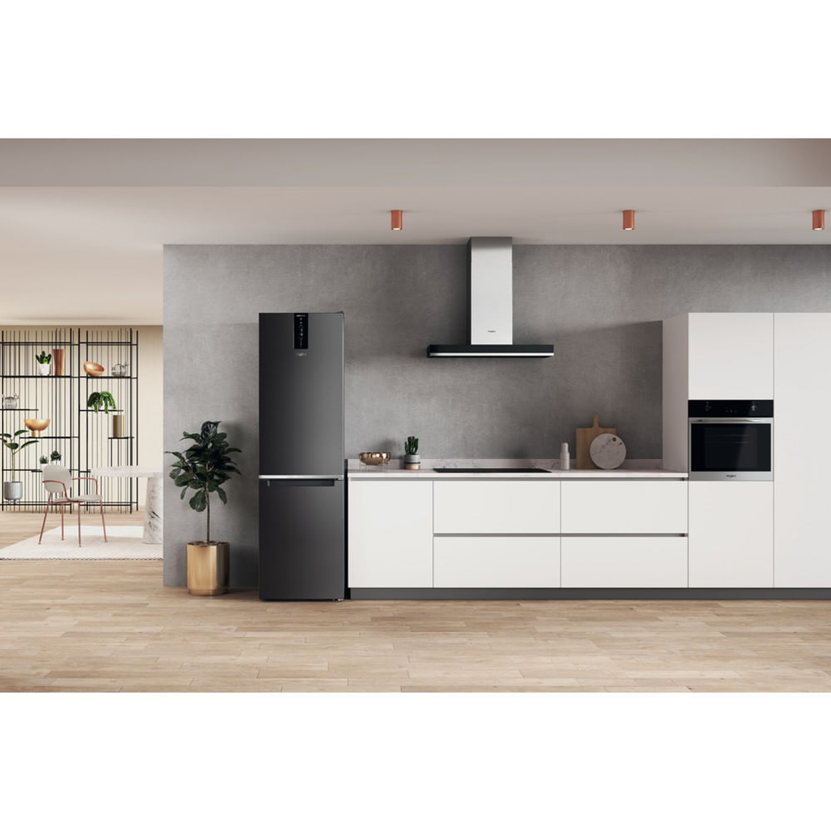 Cocina moderna con refrigerador, estufa y gabinetes negros.