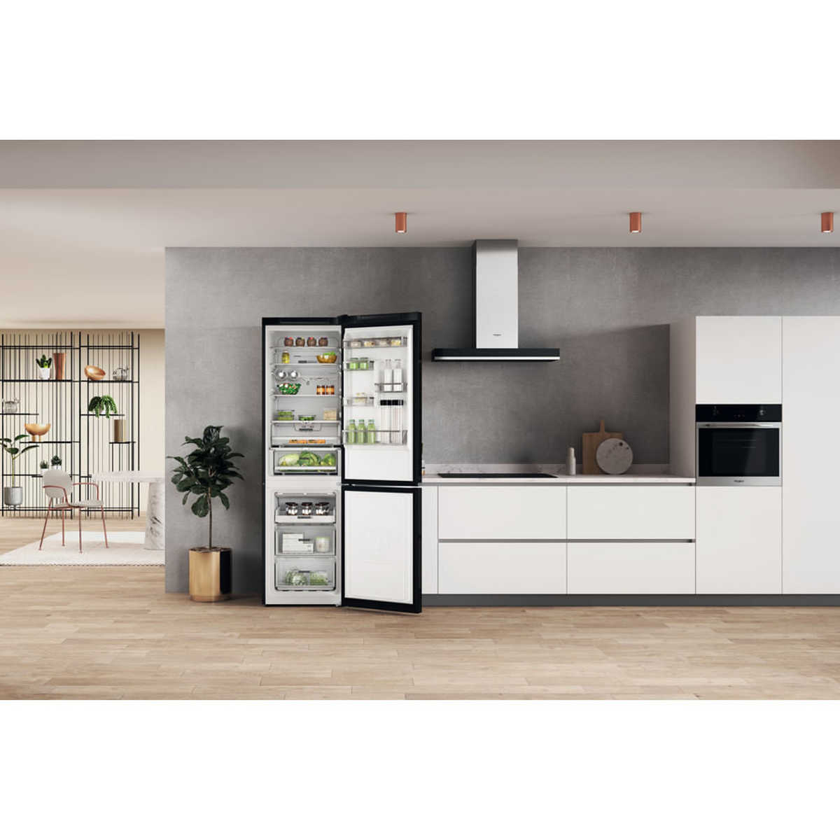 Cocina moderna con refrigerador abierto, lleno de comida y otros electrodomésticos.
