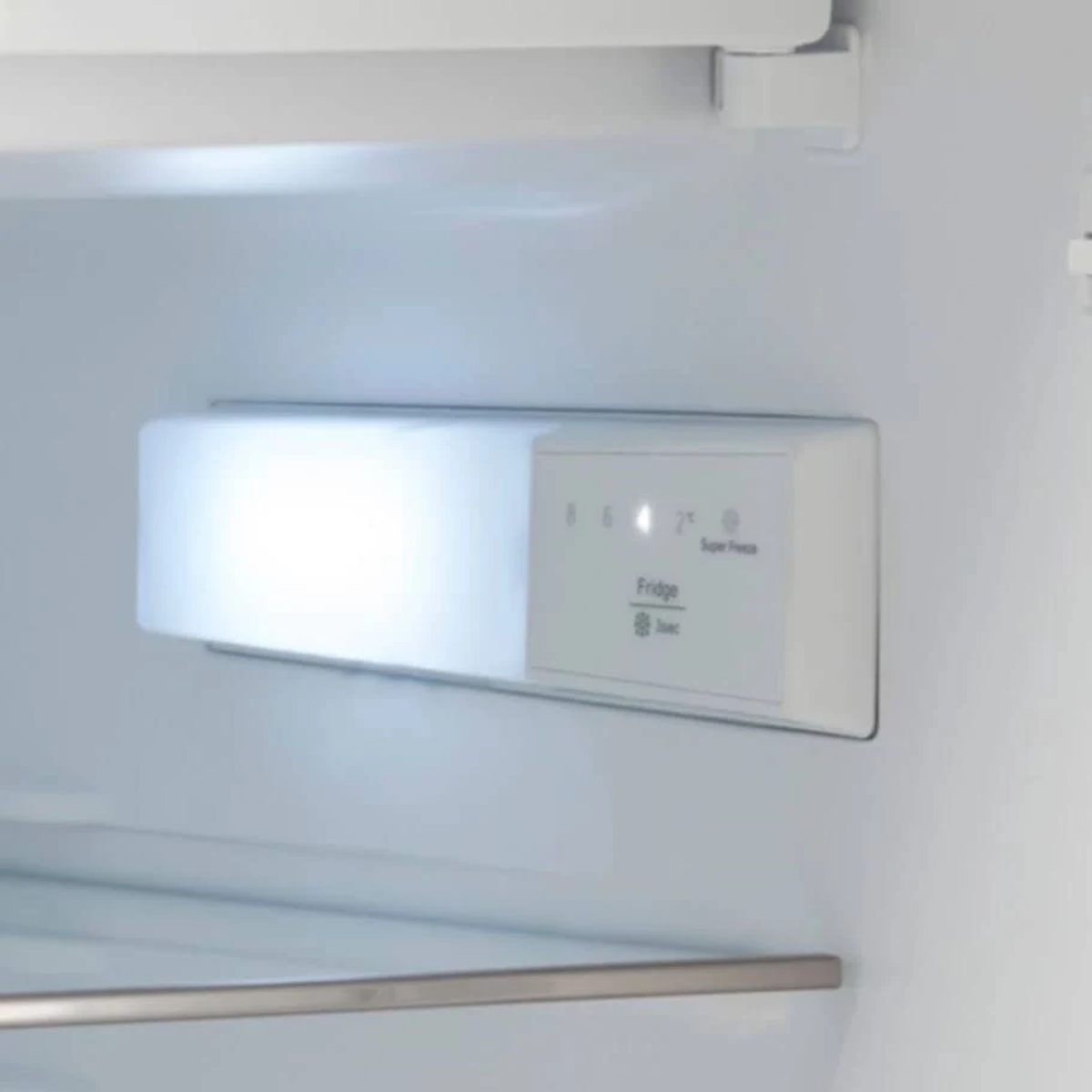 Kühlschrankinnenraum mit beleuchtetem Regal, zeigt Temperaturregler.