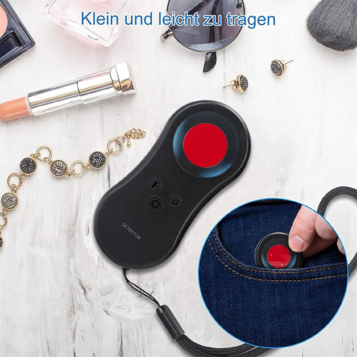 Schwarzes Detektorgerät und ein roter Kreis, auf heller Oberfläche mit Schmuck.