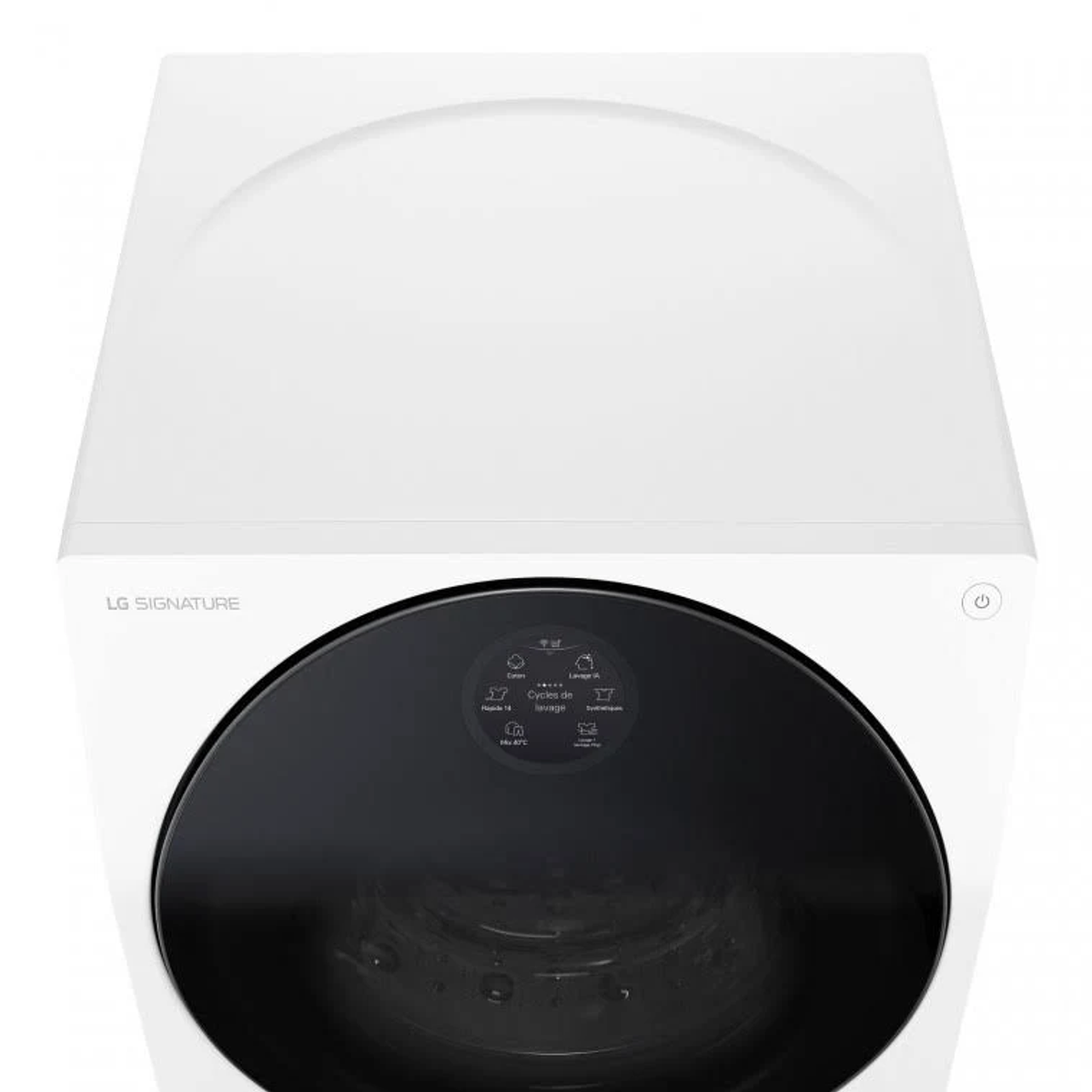 Vista superior de una lavadora blanca. Tiene una pantalla negra y un botón circular en la parte delantera.