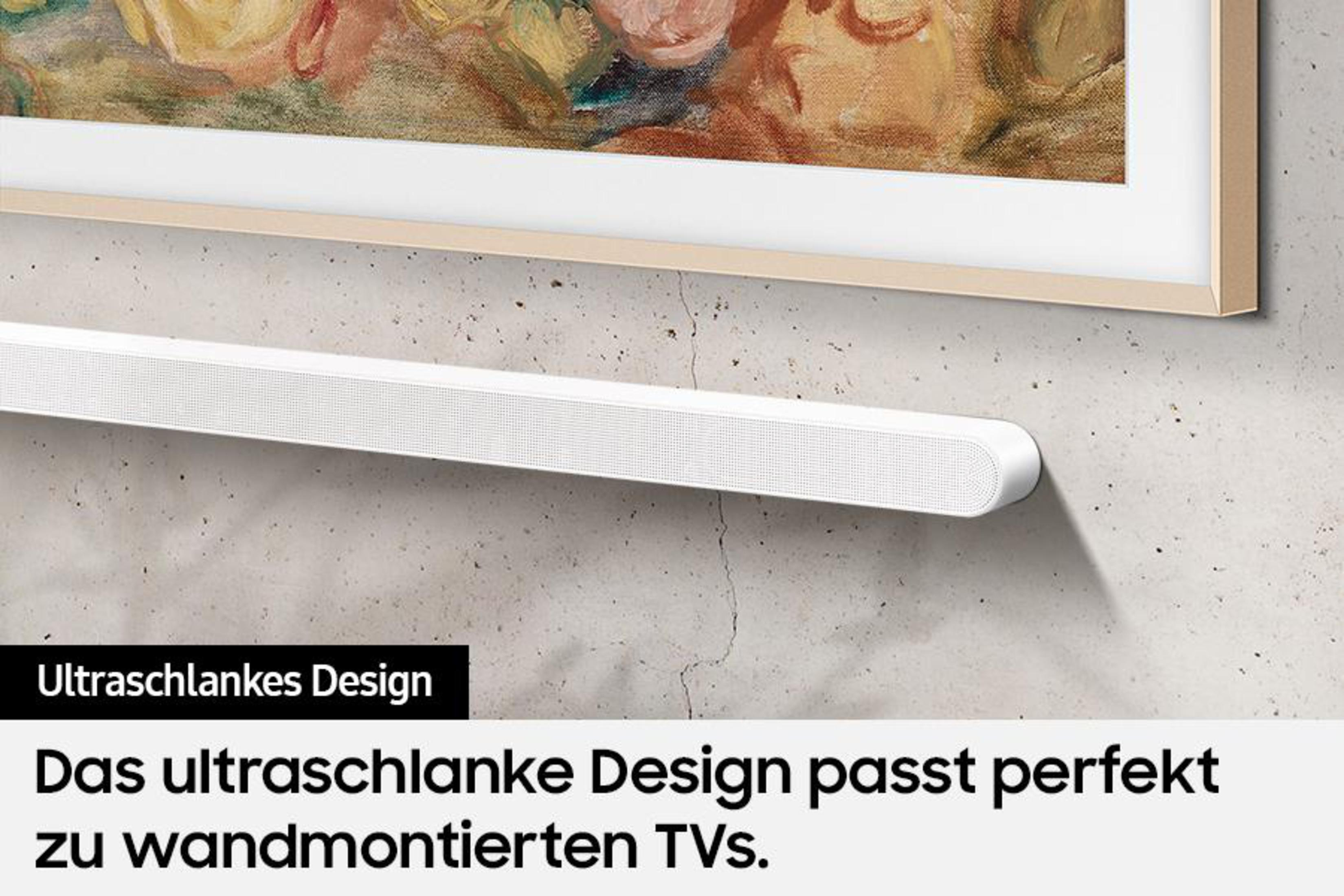 Weiße Soundbar unter einem gerahmten Gemälde an einer grauen Wand mit deutschem Text.