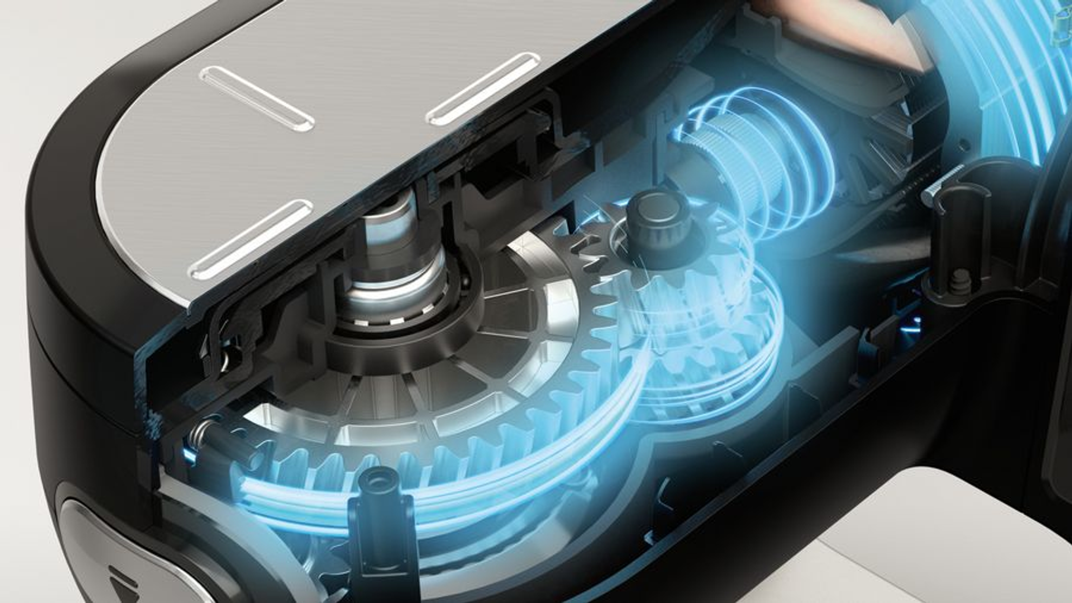 Widok wewnętrzny miksera, pokazujący koła zębate i elementy mechaniczne.