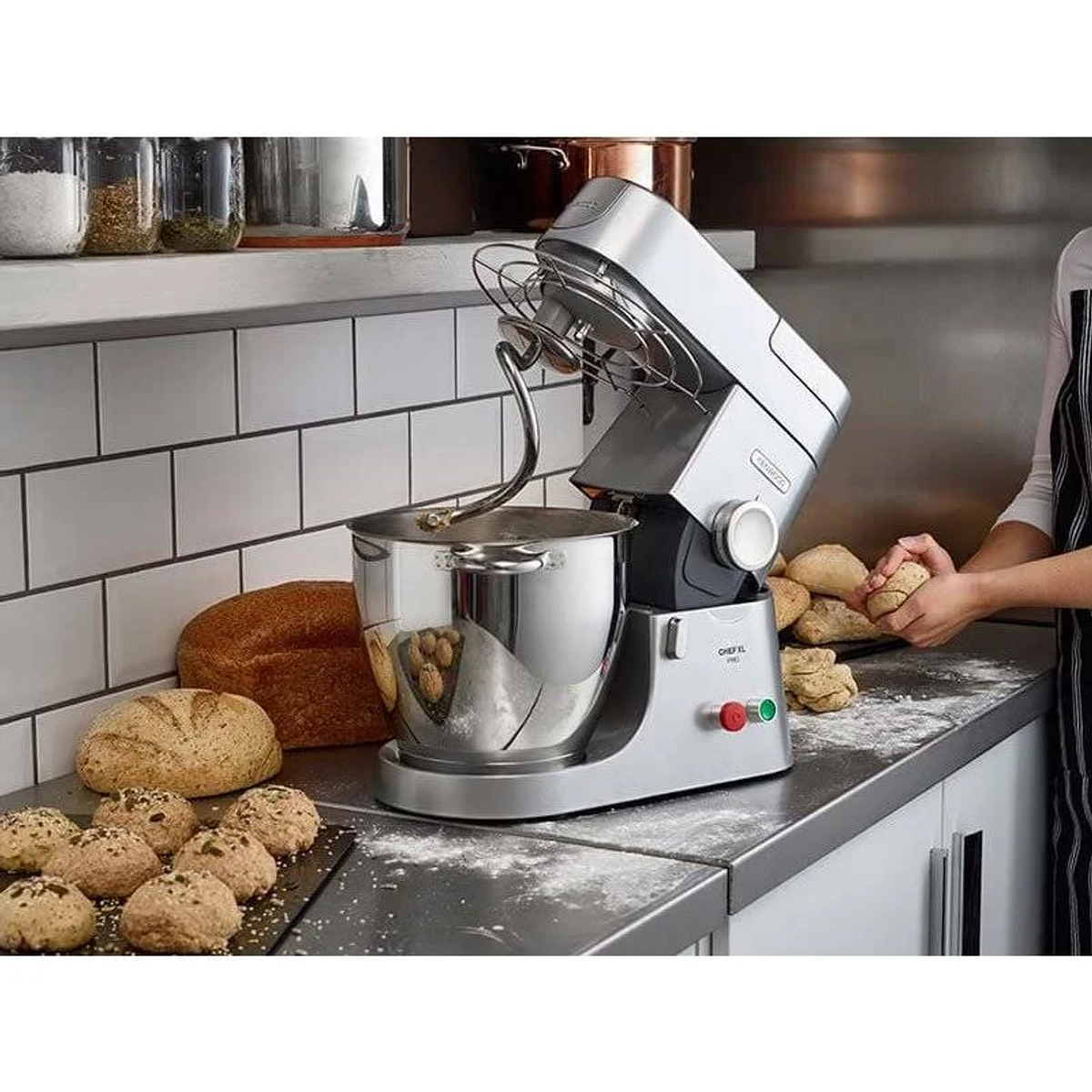Una batidora KitchenAid con masa y pan. Una persona sosteniendo masa.