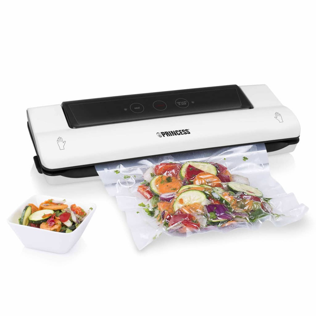 Weißer Vakuumierer und eine Schüssel mit Salat. Beutel mit bunten Gemüse wird verschweißt.