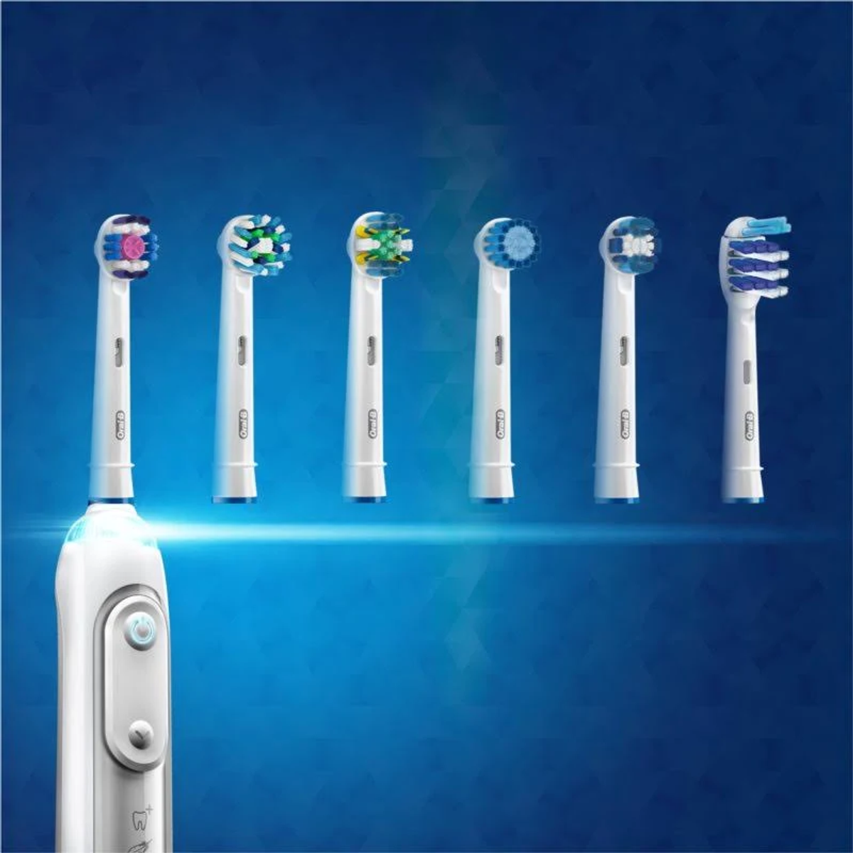 Six Oral-B toothbrush heads with various colored bristles are on a blue background. One toothbrush handle is visible.
