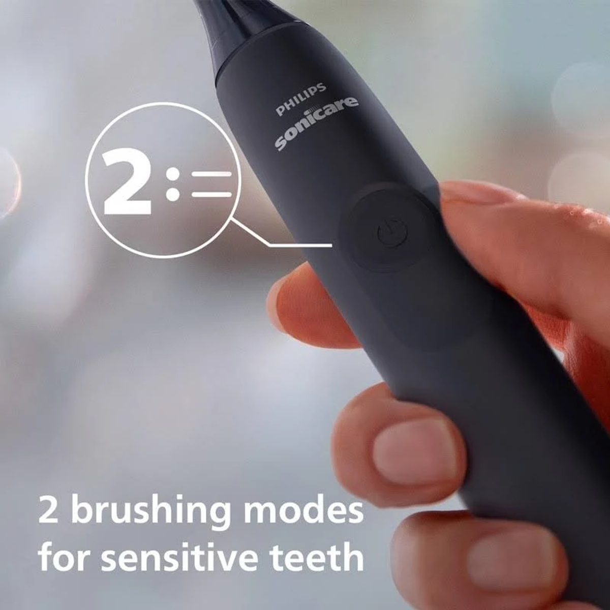 Zbliżenie szczoteczki Philips Sonicare z tekstem o trybach szczotkowania.