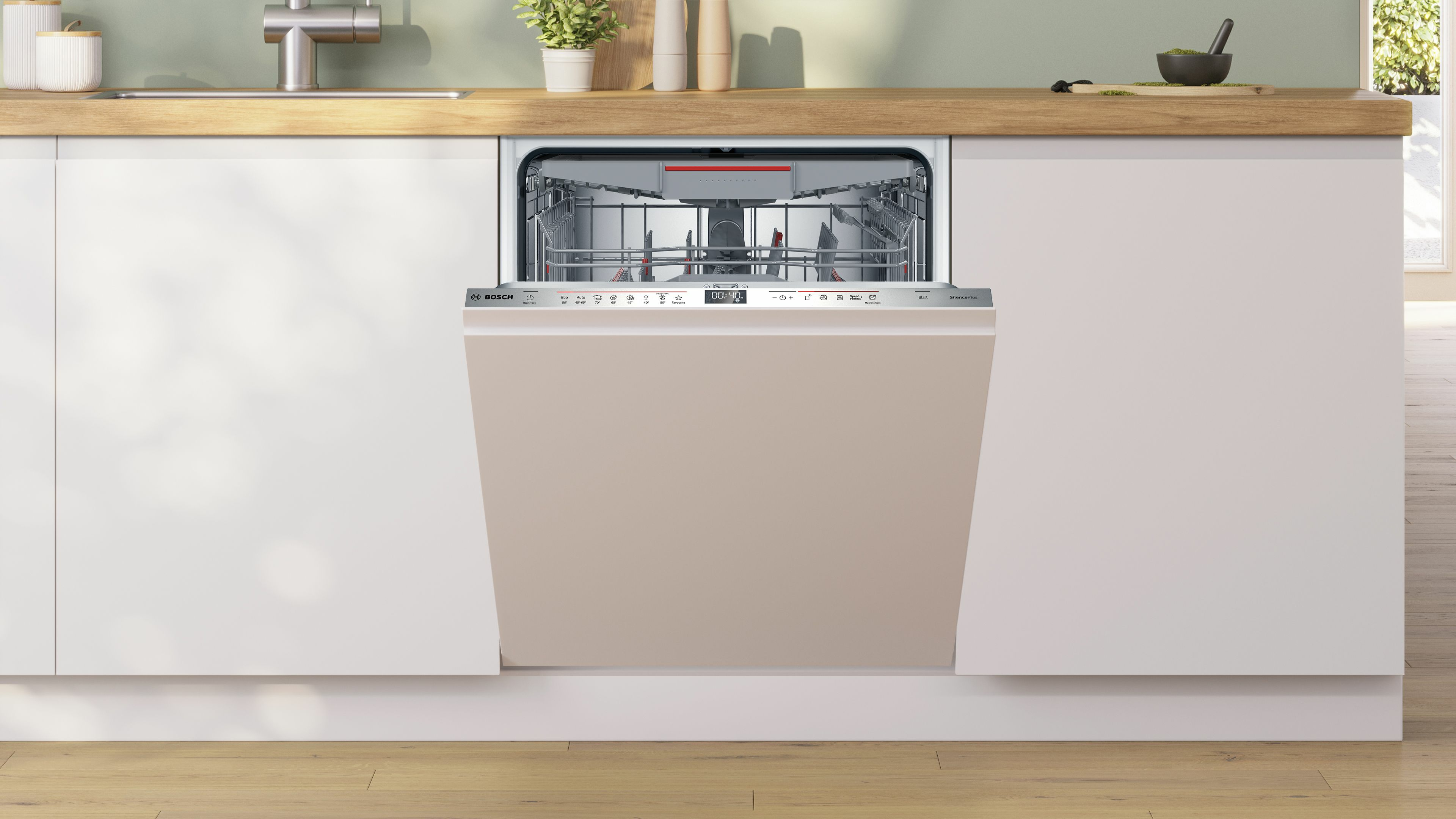 Un lavavajillas Bosch empotrado con un panel frontal beige. Está situado en una cocina blanca con encimeras de madera.
