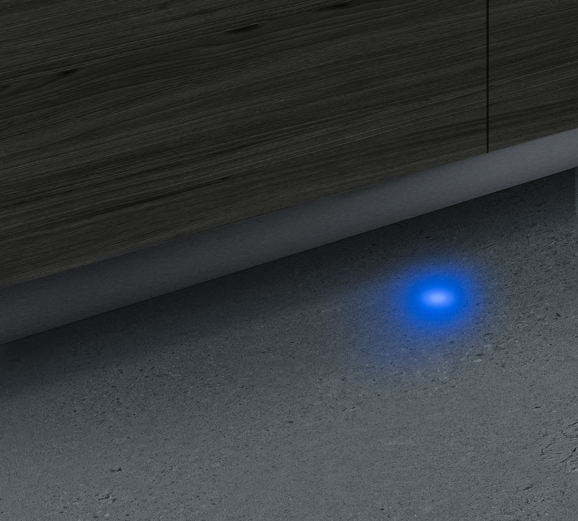 Une lumière bleue brillant sur un mur de béton.