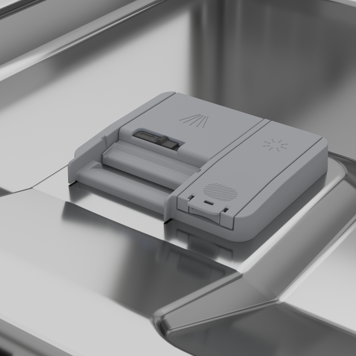 Otwarty dozownik do płynu do zmywarki. Szary plastik. Srebrne wnętrze. Metaliczne, błyszczące tło.