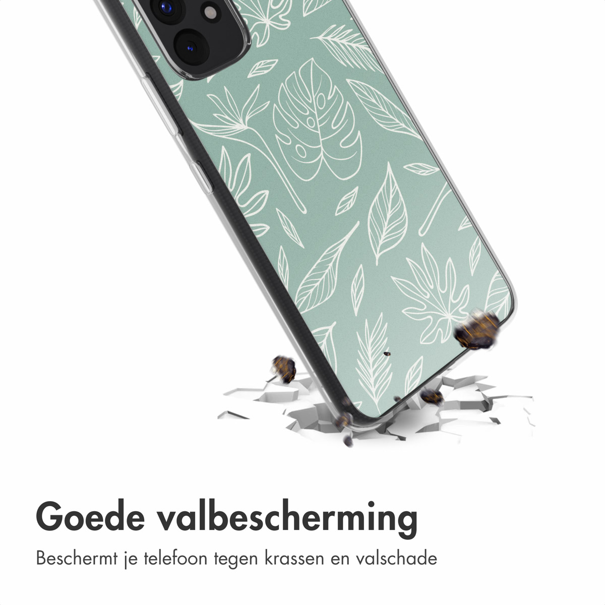 Custodia per telefono con un design a foglie bianche e verdi. Il telefono è a terra, incrinato.