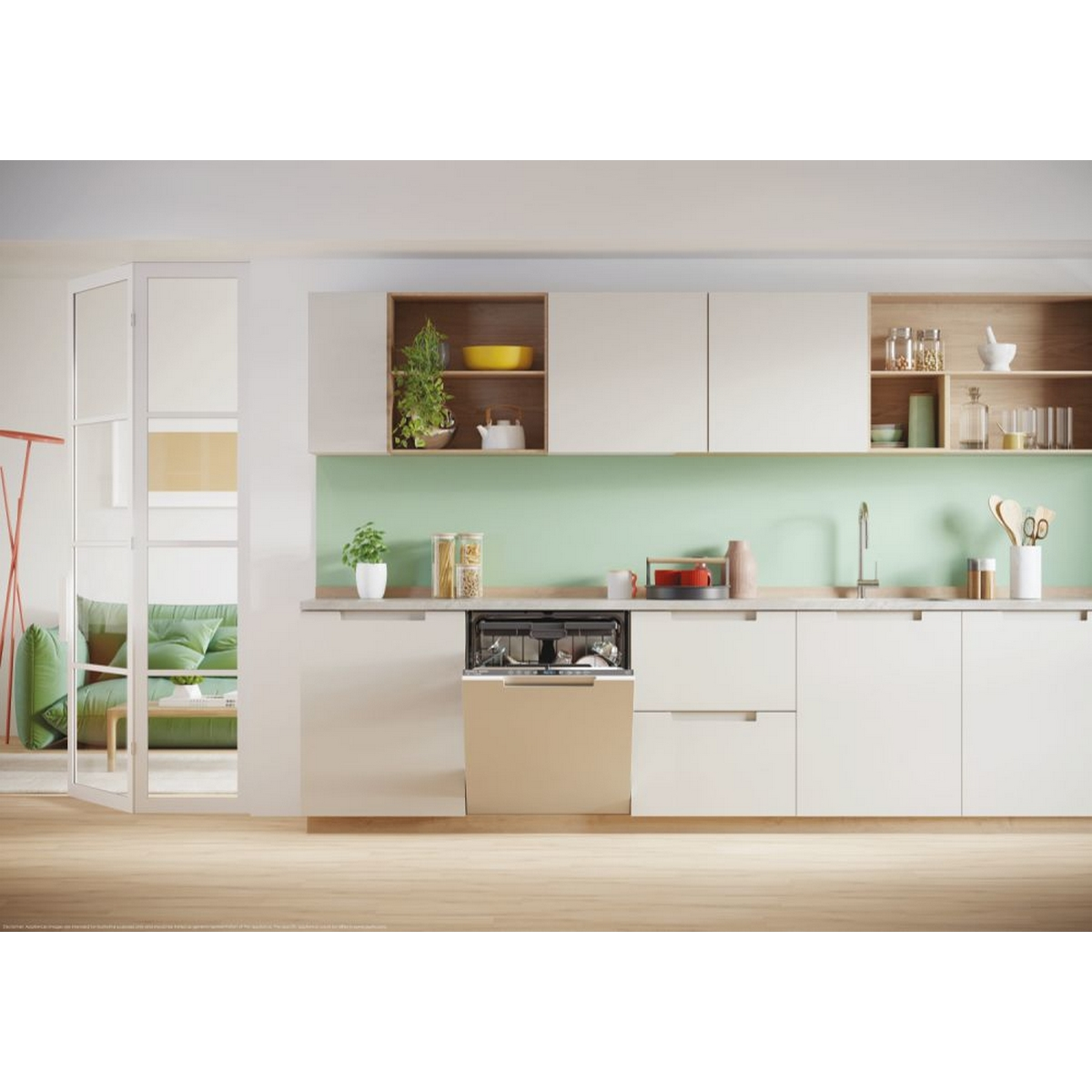 Moderne Küche mit beigefarbenen Schränken, einem Geschirrspüler und einer grünen Wand. Holzboden und Sofa im Hintergrund.