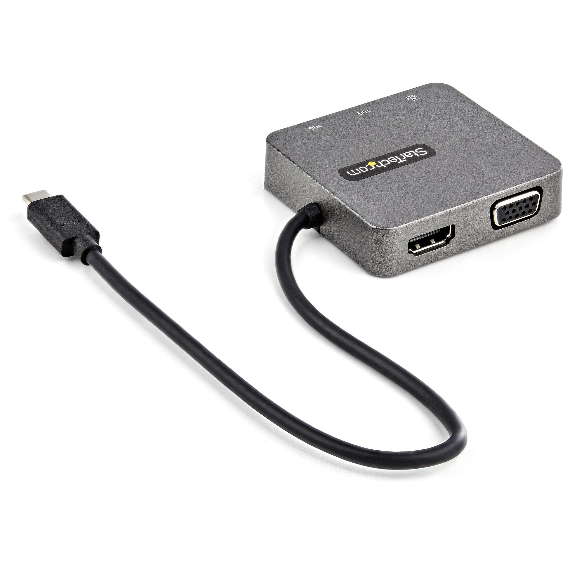 Concentrador USB-C gris con múltiples puertos. Incluye cable USB-C, puertos HDMI y VGA. Fondo blanco.
