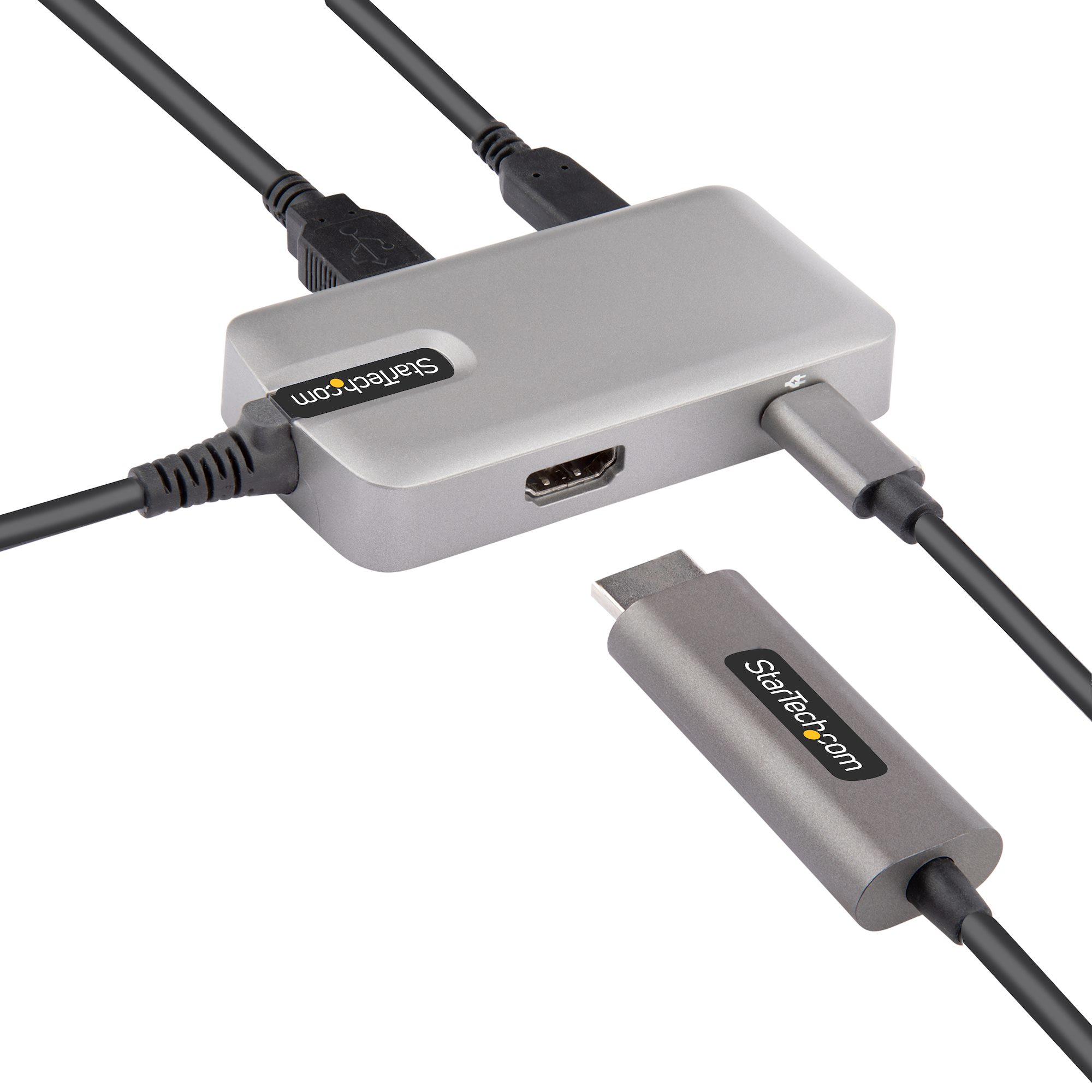 Concentrador gris Startech.com con múltiples puertos. Cables negros y un adaptador USB-C.