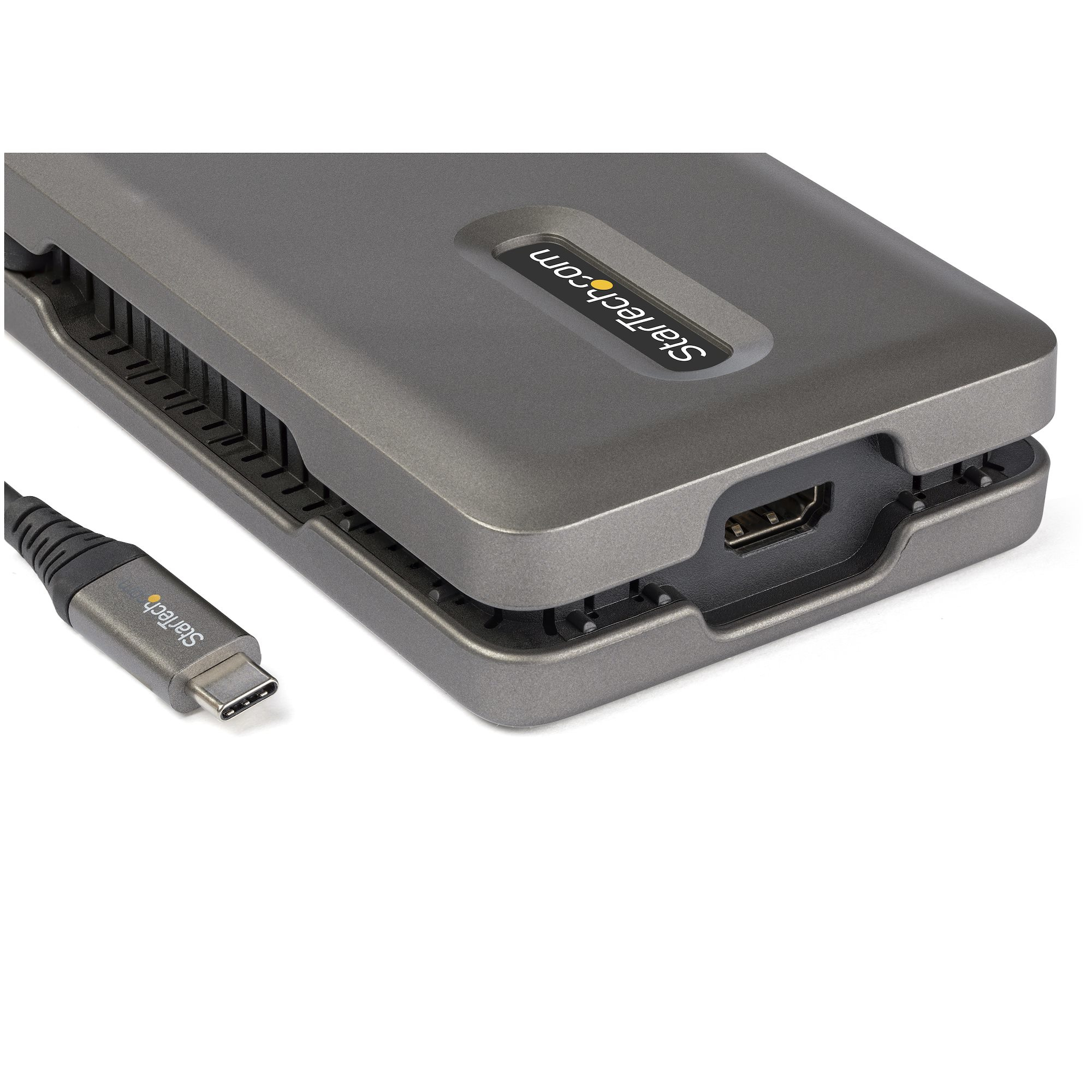 Un disco duro externo gris con un cable conectado. El logotipo de Startech es visible.