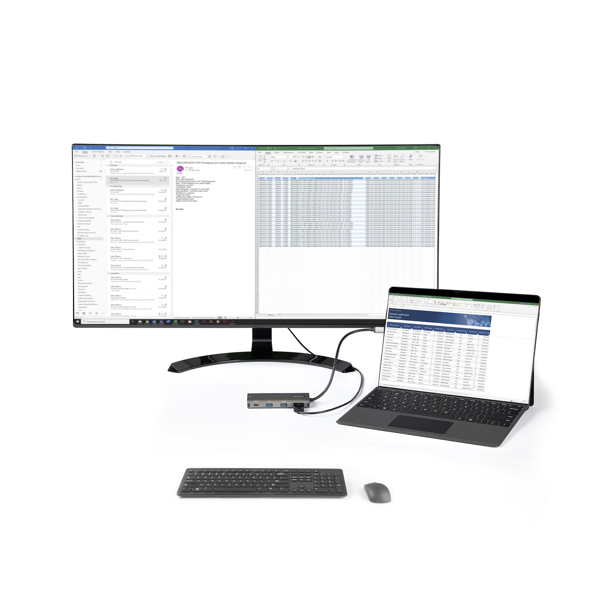 Un portátil conectado a un monitor, teclado y ratón. Interfaces de hoja de cálculo y correo electrónico son visibles.