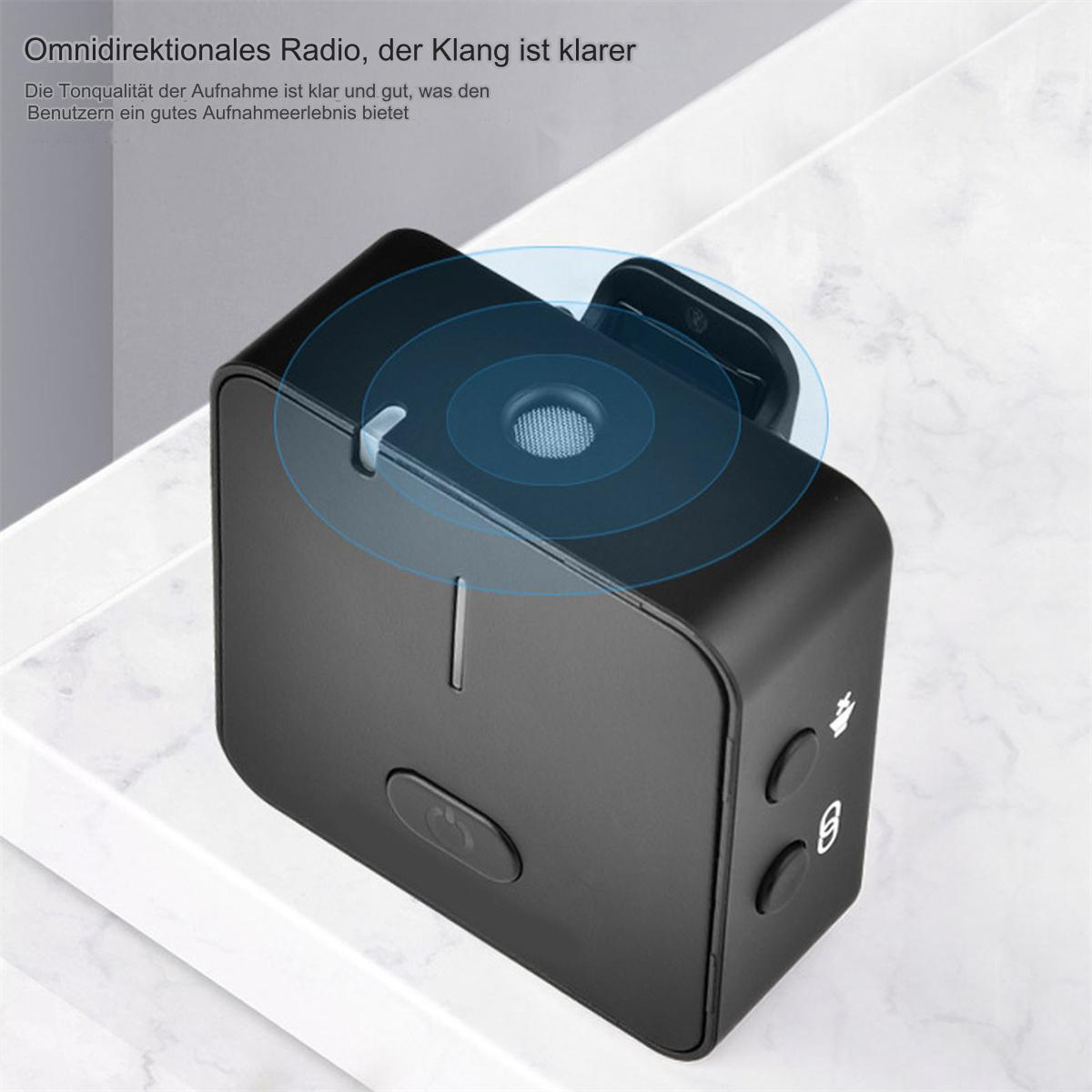 Ein schwarzes rechteckiges Gerät mit Knöpfen und kreisförmigen Designs auf einer weißen Oberfläche.