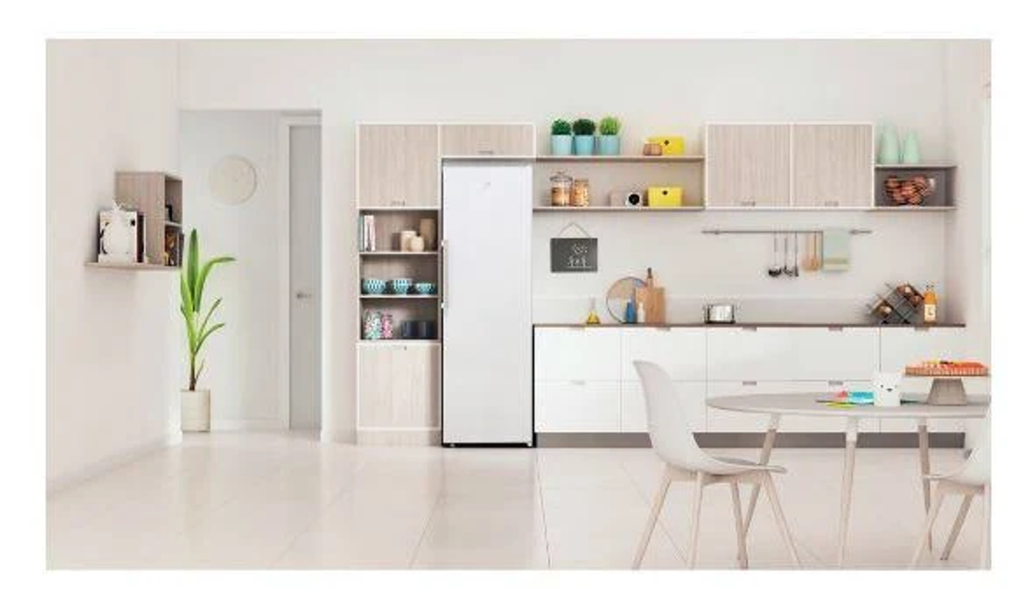 Cocina con nevera blanca, armarios, mesa redonda y planta. Tonos blancos y madera.