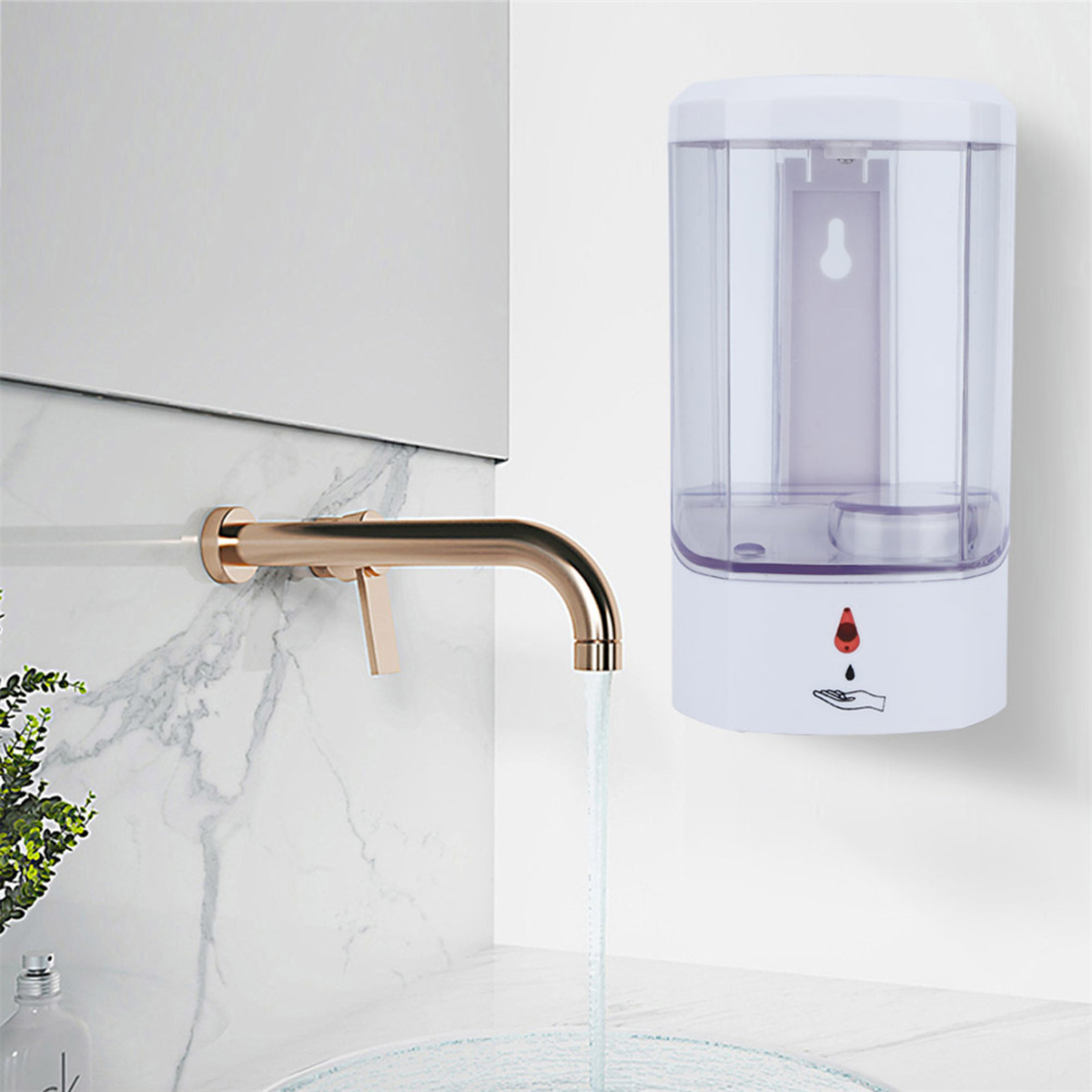 Ein Wandseifenspender mit goldenem Wasserhahn, Wasser fließt. Weißer Hintergrund.