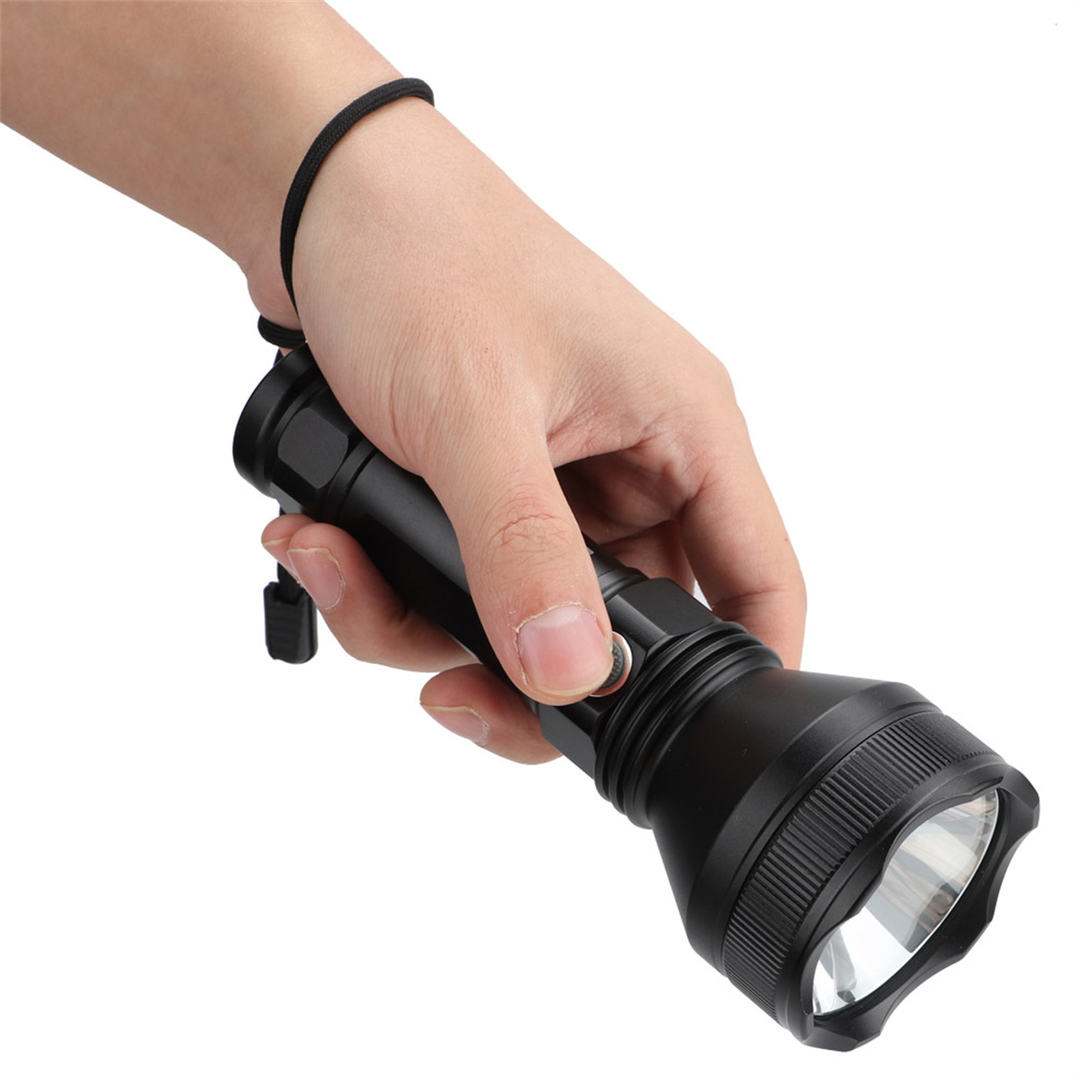 Eine Hand hält eine schwarze Taschenlampe. Die Taschenlampe ist eingeschaltet und der Hintergrund ist weiß.