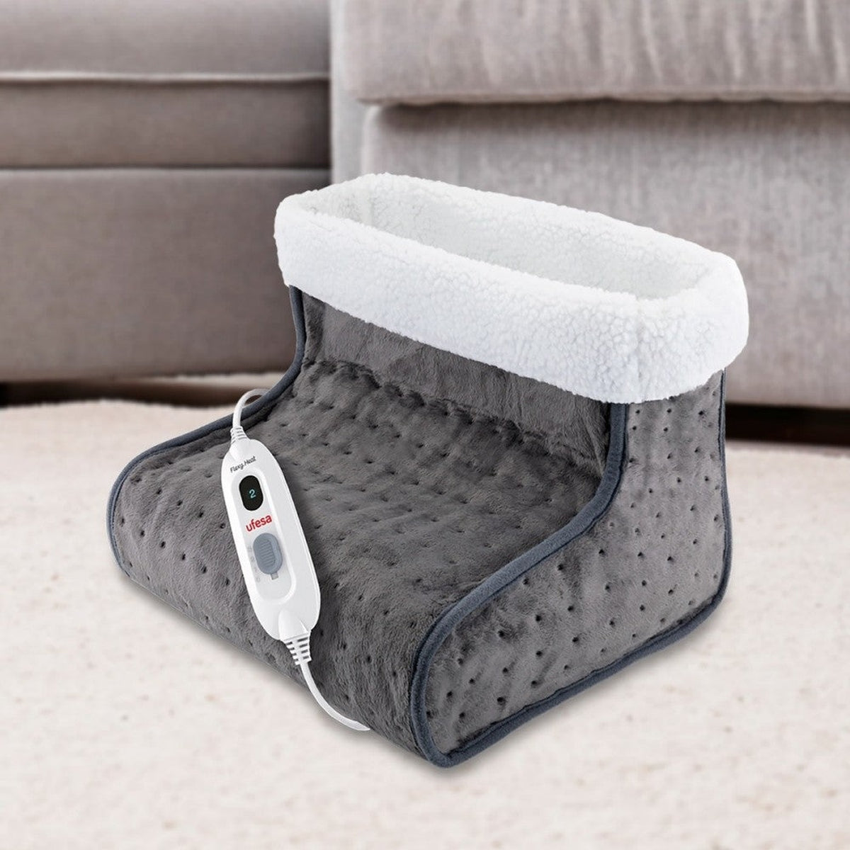Szary podgrzewacz do stóp. Białe, puszyste wnętrze. Sterowanie na kablu.