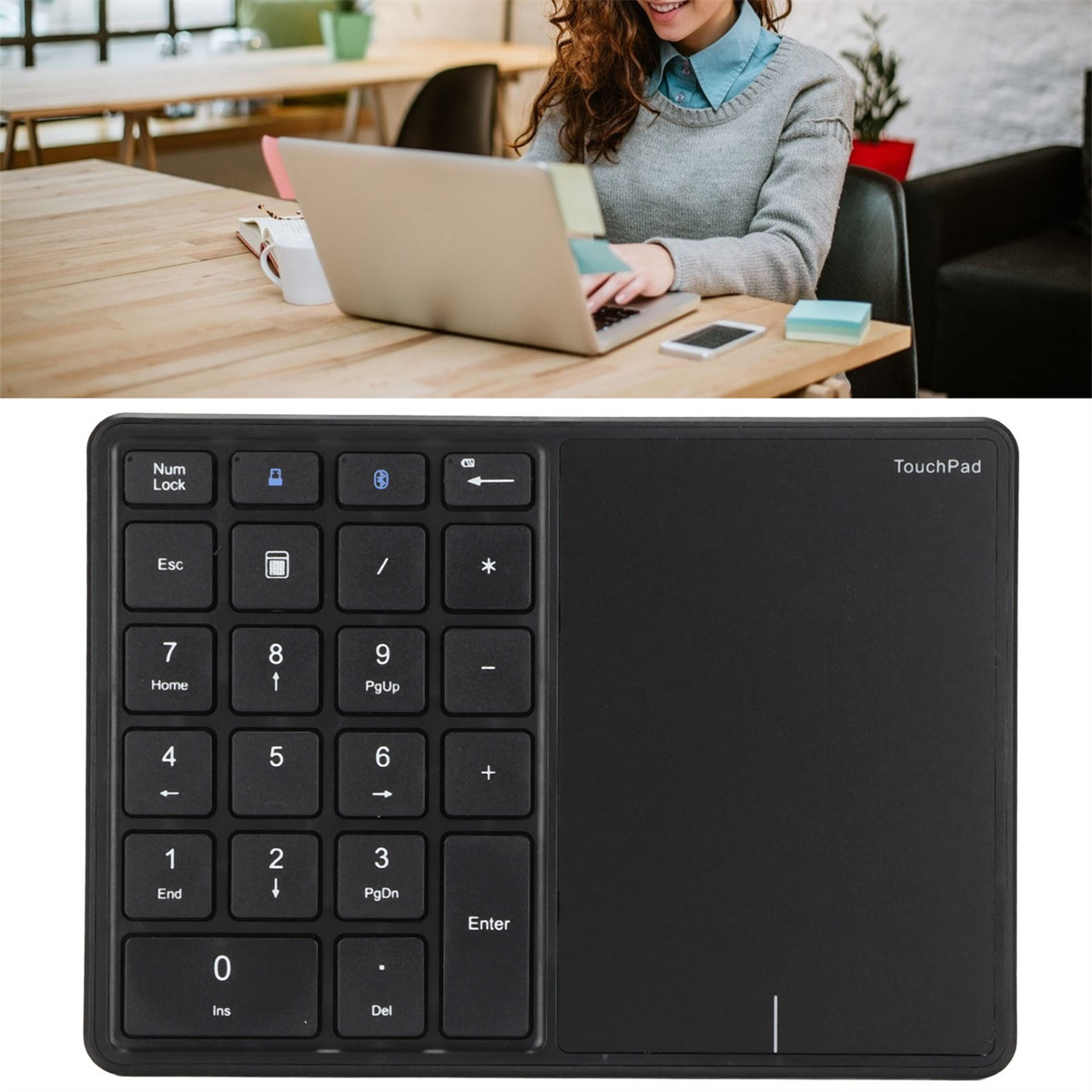 Schwarzer Ziffernblock mit Touchpad. Person benutzt Laptop im Hintergrund.