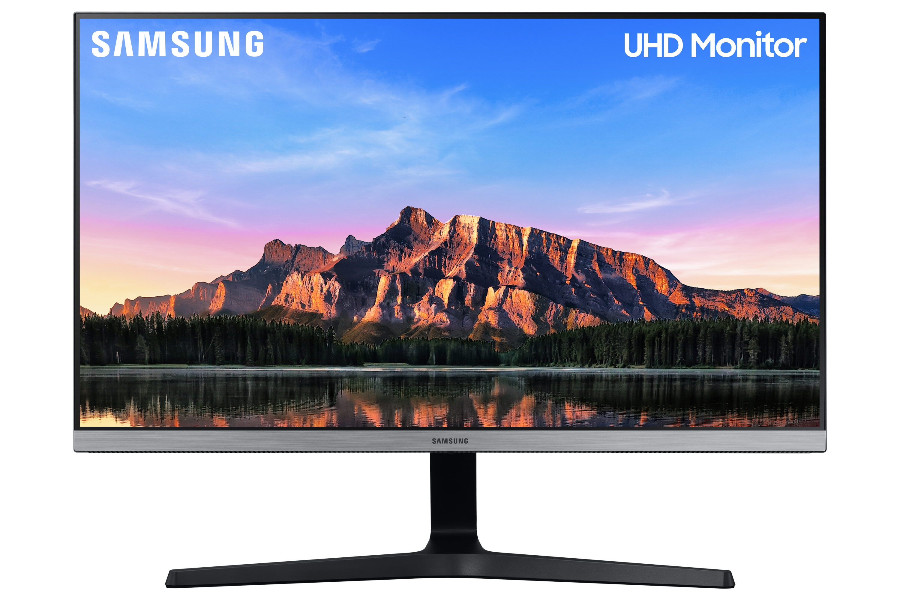 Un monitor Samsung UHD que muestra un paisaje con montañas y agua.