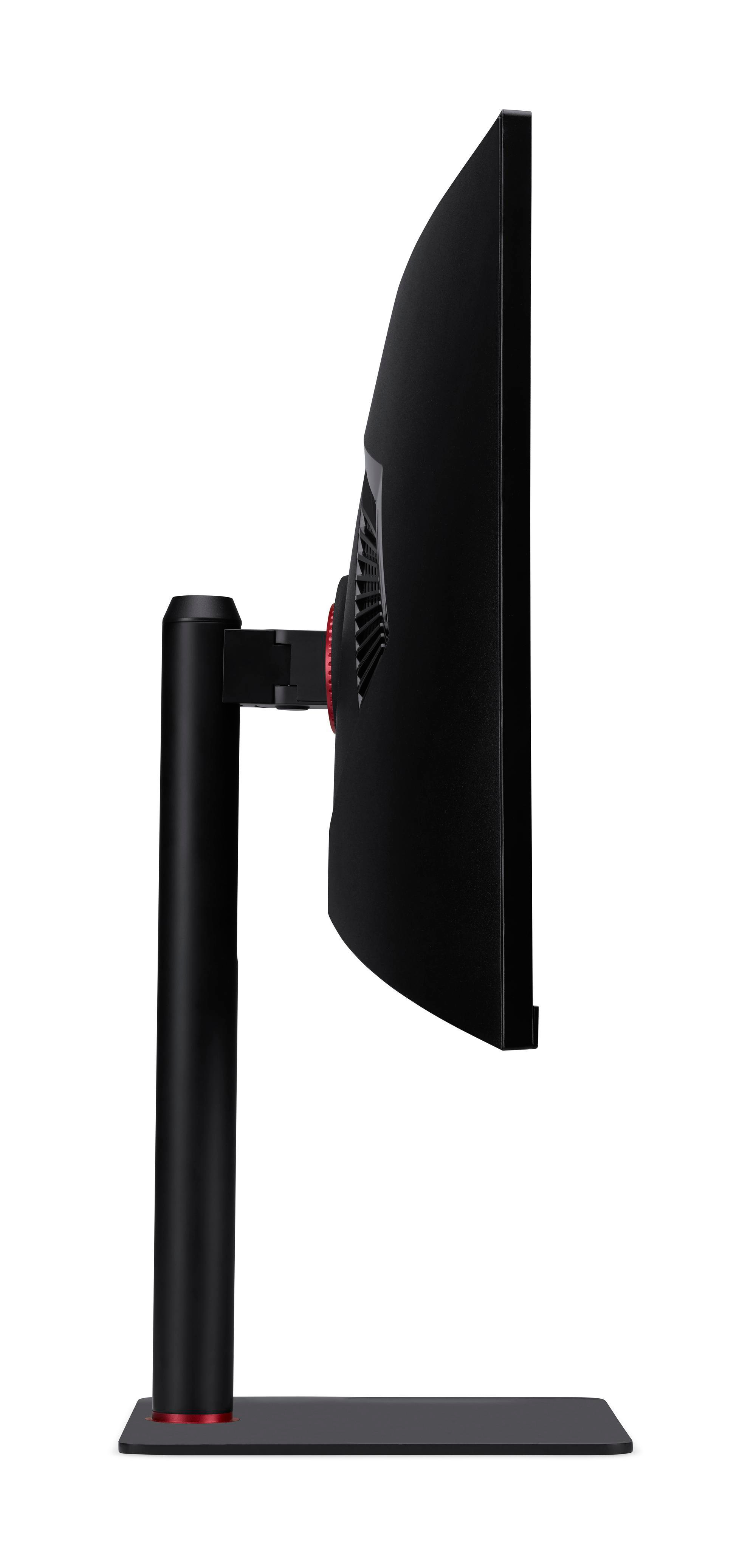 Widok z boku czarnego monitora komputera z czerwonym akcentem na podstawie i zakrzywionym ekranem.