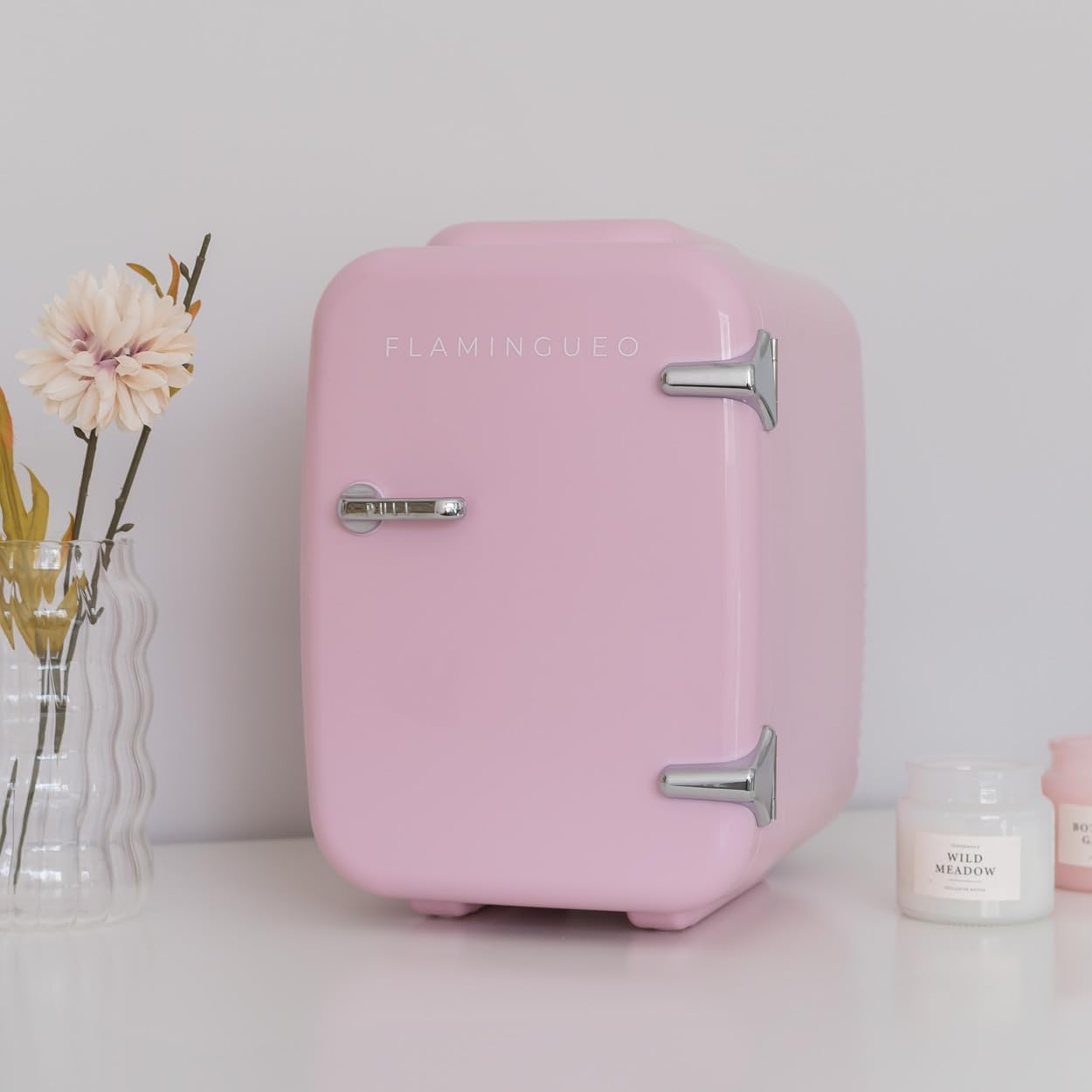 Mini nevera rosa con asas plateadas y la palabra FLAMINGUEO.