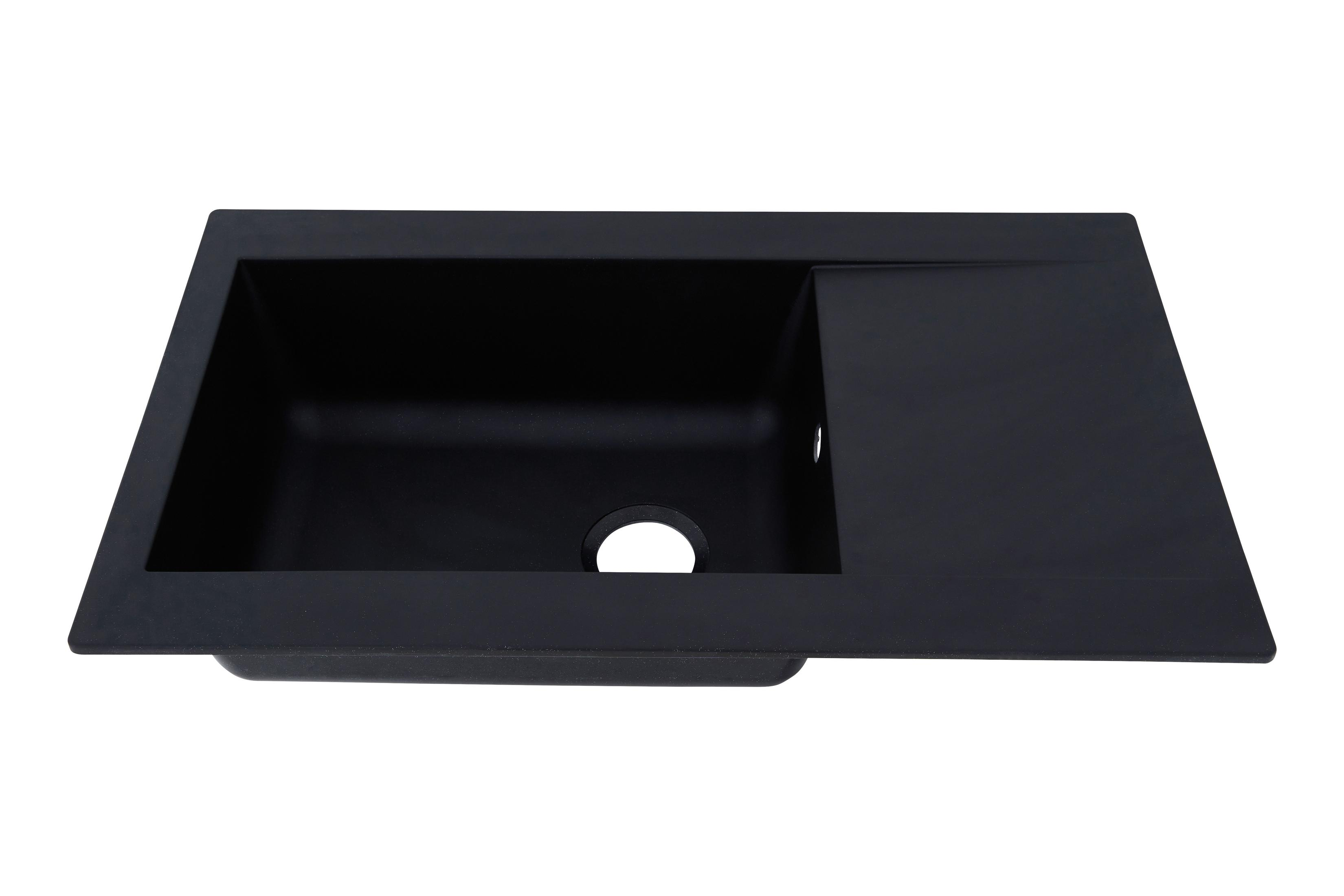 Ein schwarzes Küchenbecken mit eingebauter Abtropffläche. Es ist rechteckig.