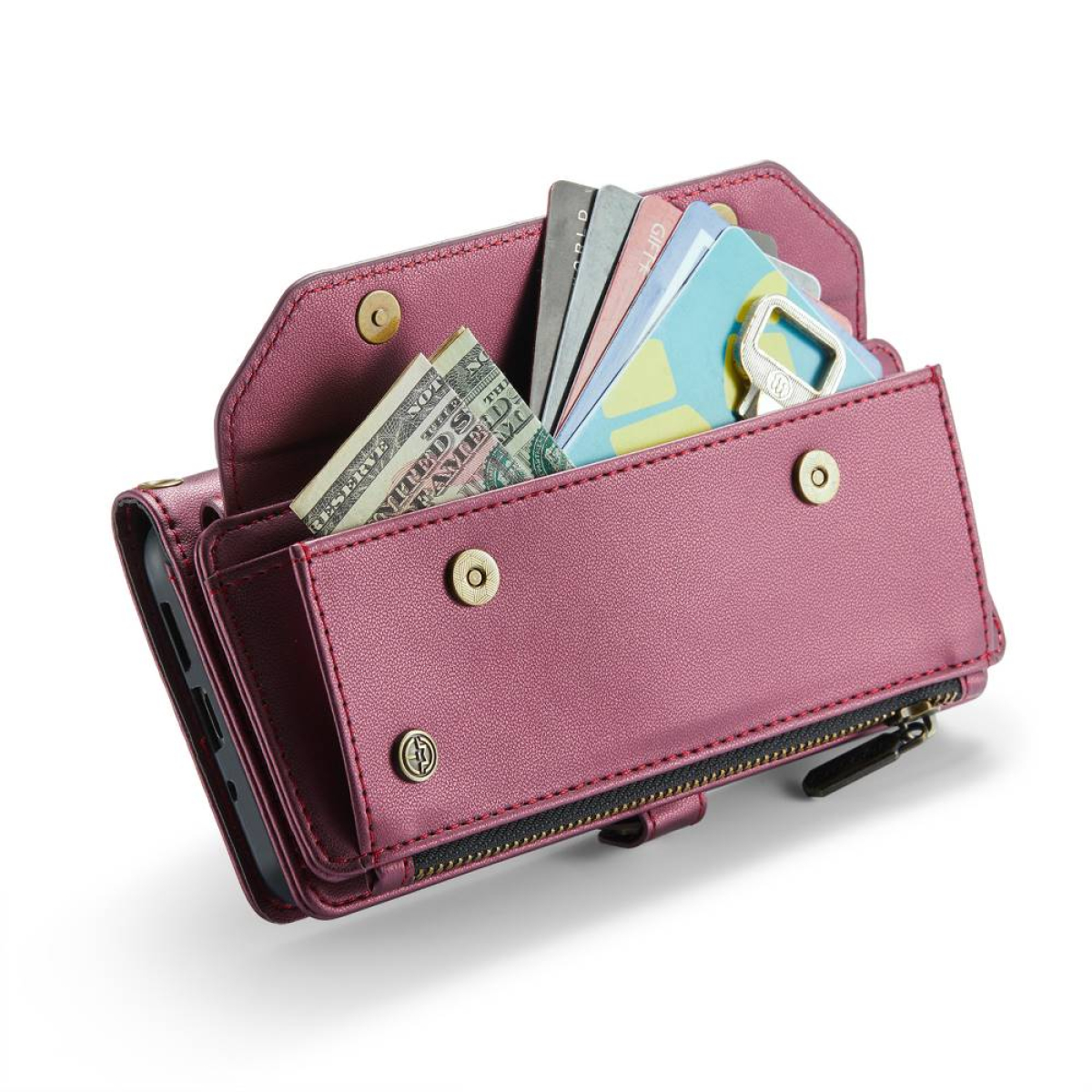 Geöffnete pinkfarbene Ledergeldbörse mit Bargeld, Karten und Telefon. Knöpfe und Reißverschluss sind sichtbar.