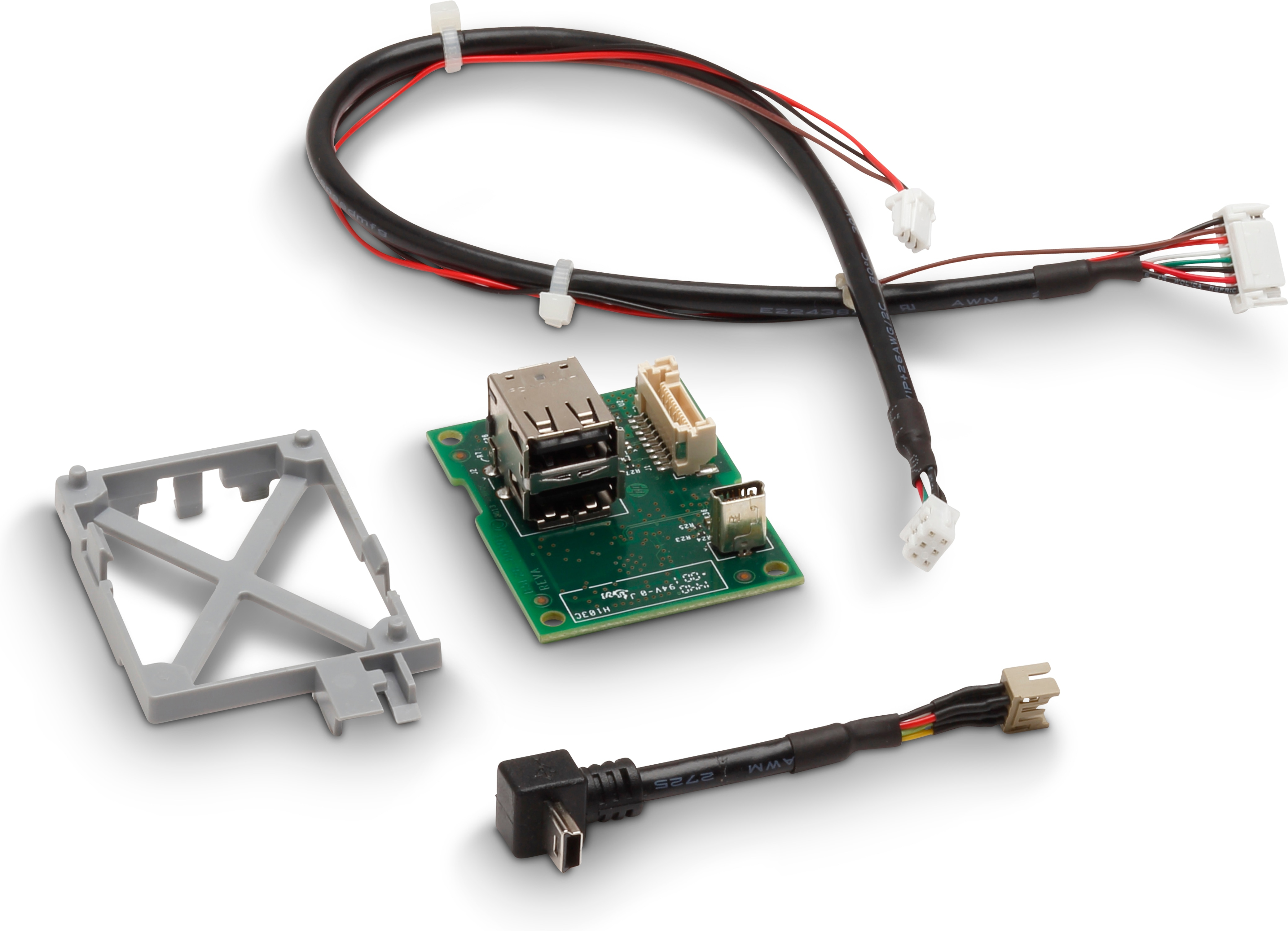 Elementy elektroniczne: zielona płytka drukowana z portami, kabel USB i mała szara ramka.