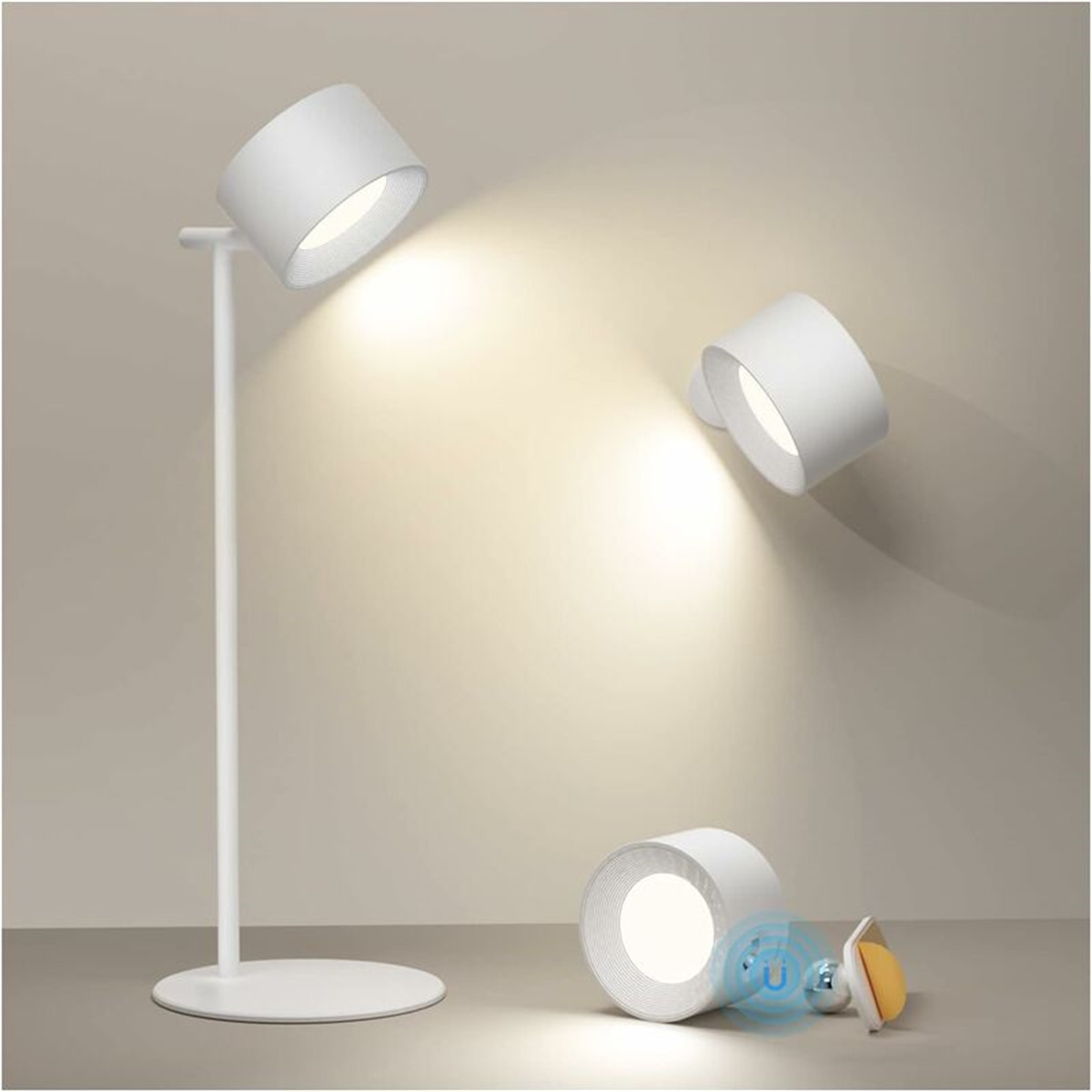 Drei weiße, zylindrische Lampen, zwei beleuchtet. Eine steht auf einem Ständer, die anderen auf dem Boden. Der Hintergrund ist neutral.