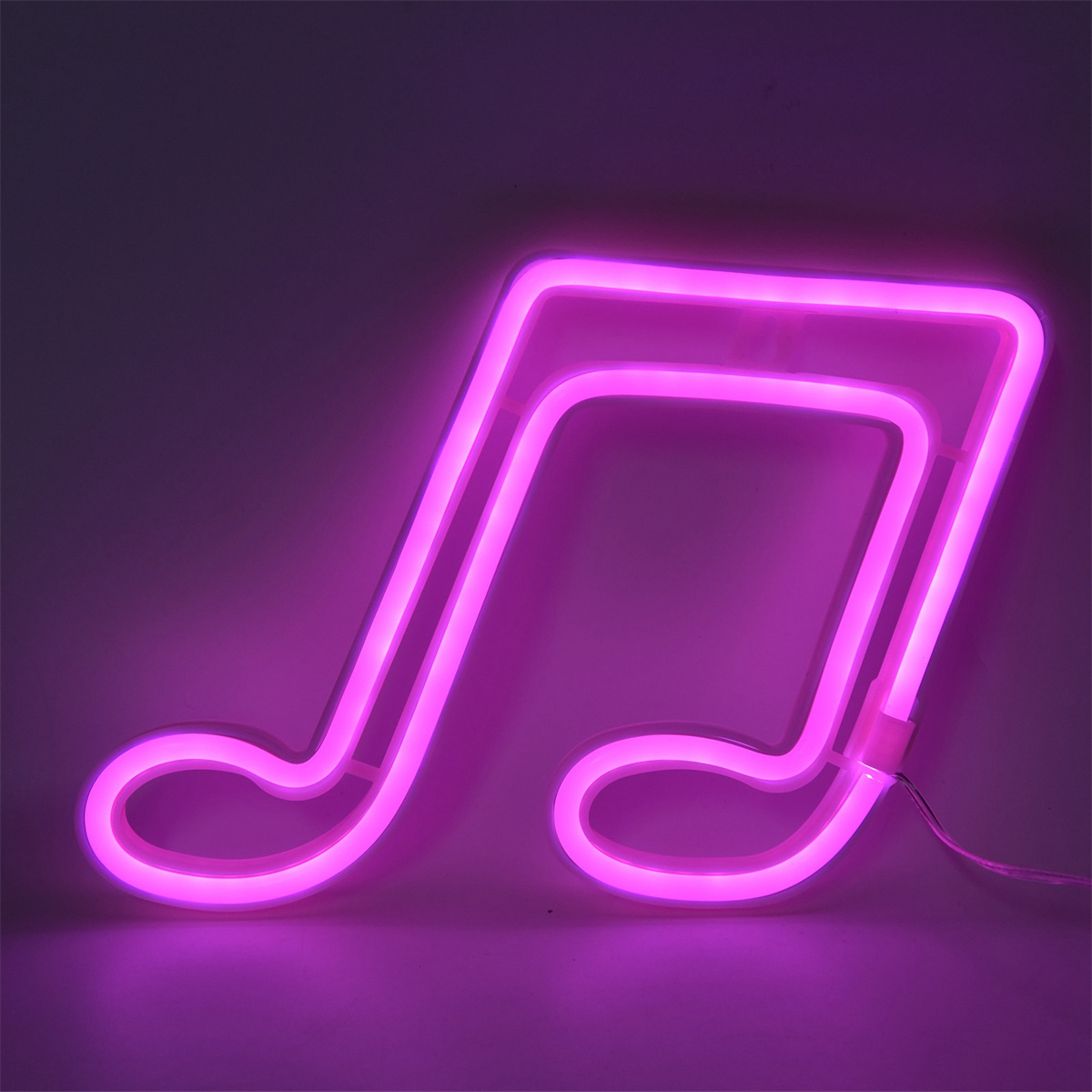 Rosa Neon-Notenzeichen auf einem Hintergrund mit Farbverlauf.