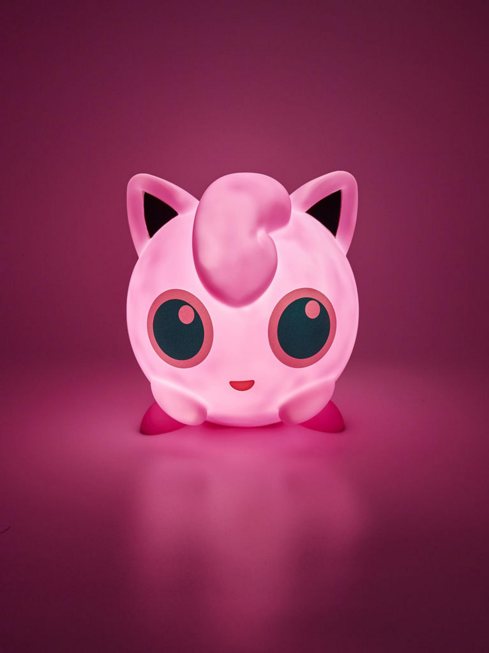 Lampada rosa di Jigglypuff luminosa. Ha grandi occhi e una parte superiore arricciata, su sfondo rosa.