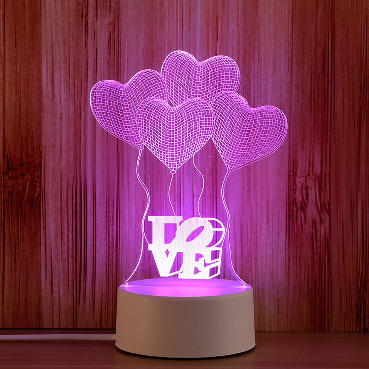 Ein rosa LED-Liebesschild mit Herzballons vor einem Holzmaserungshintergrund.