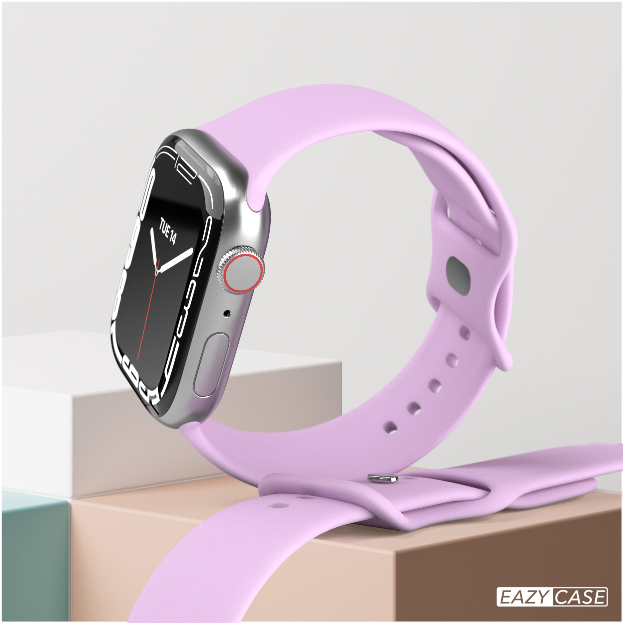 Eine silberne Smartwatch mit lila Armband liegt auf cremefarbener Oberfläche.