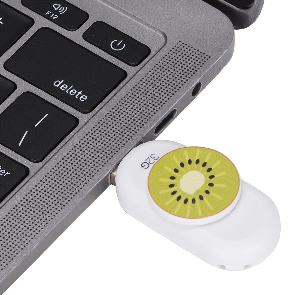 Ein weißer USB-Stick mit Kiwi-Frucht-Design, der in einen Laptop eingesteckt ist.