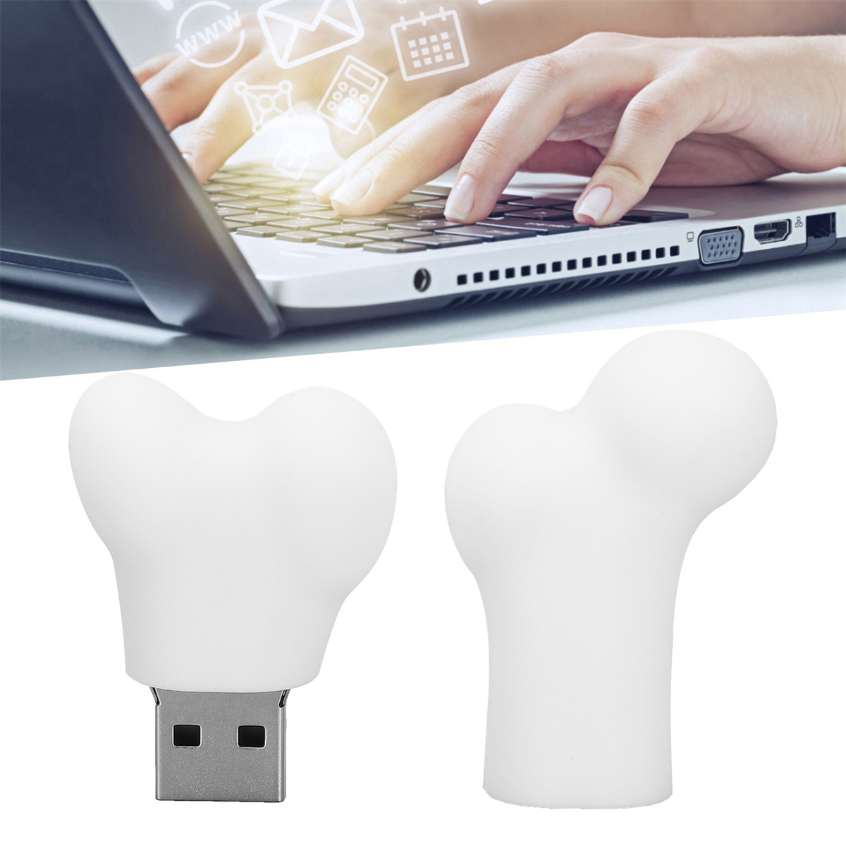 Zwei weiße USB-Laufwerke in Knochenform, mit Händen auf einem Laptop.