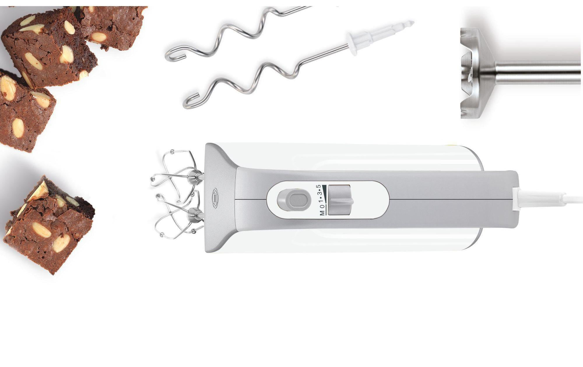 An overhead shot of a white hand mixer with attachments and brownies with nuts.