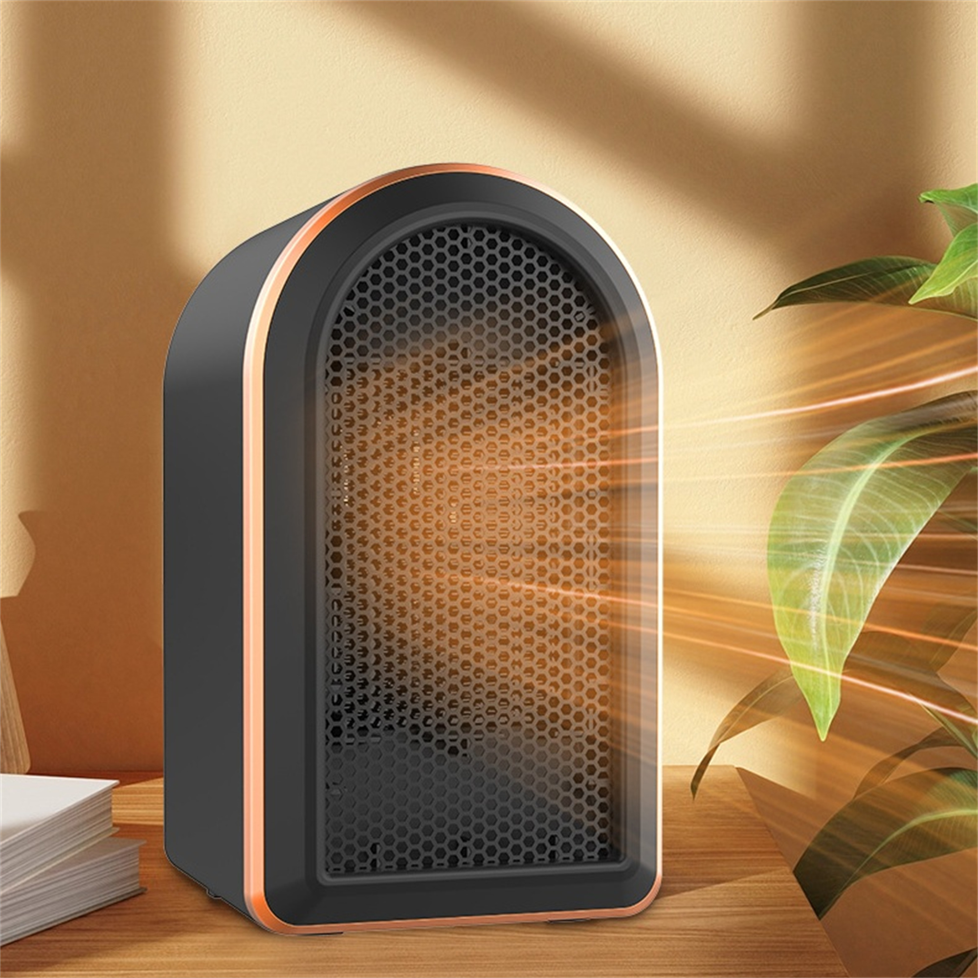 Schwarz-oranger Elektroheizer auf einem Holztisch, mit Pflanzen im Hintergrund.