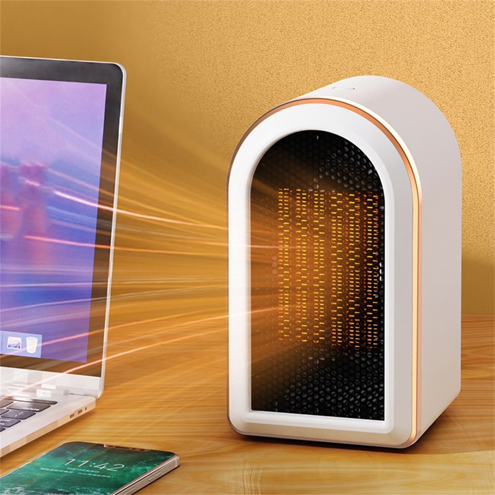 Weiß-goldener Mini-Heizkörper auf dem Schreibtisch. Ein Laptop und ein Telefon mit Zeitanzeige sind ebenfalls sichtbar.