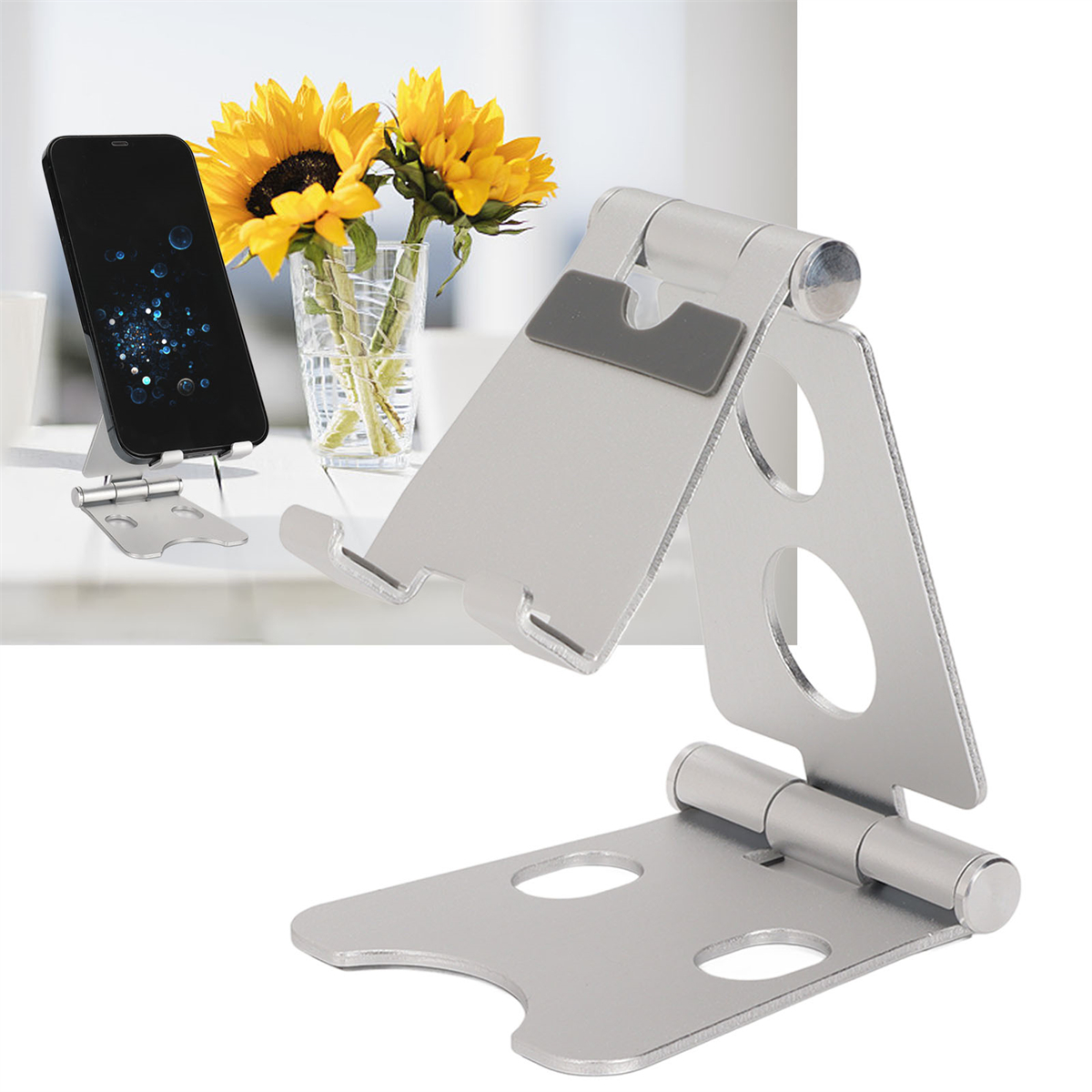 Ein silberner Telefonständer, der ein Telefon neben einer Vase mit Sonnenblumen hält.